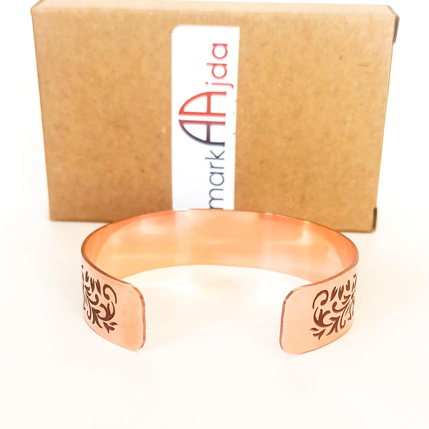Back display of engraved Ayat ul Kursi cuff bracelet in natural light.