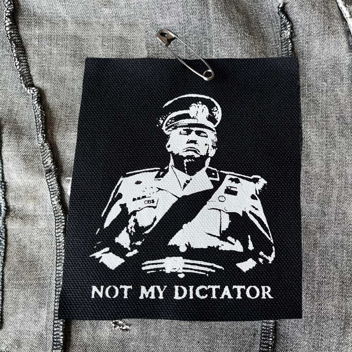 Black and white punk protest patch featuring anti-authoritarian statement art