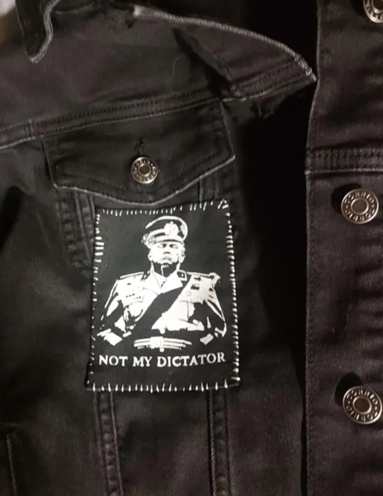 Punk battle vest patch with bold political message and stitched DIY details