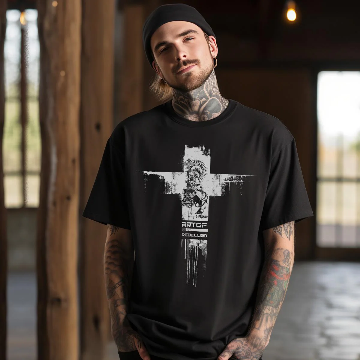 May include: A black t-shirt with a white graphic design of a cross with a figure in the center. The text 'ART OF REBELLION' is below the cross.