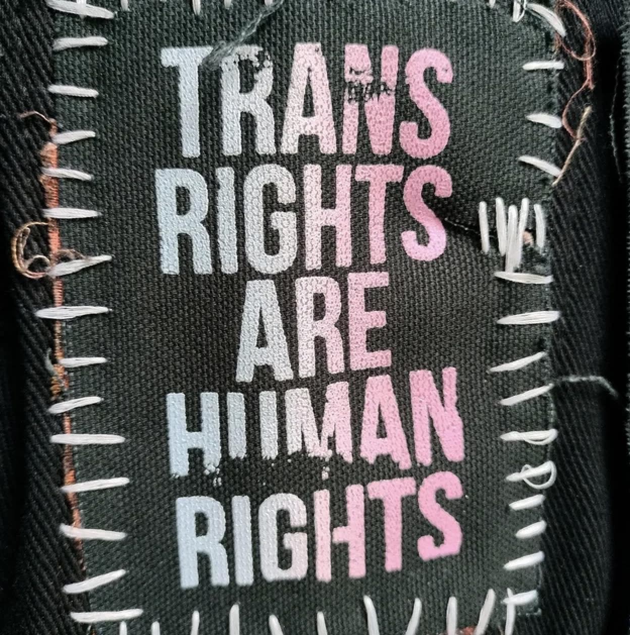 Ombre punk patch in trans flag colors with bold 'Trans Rights' message, perfect for battle jackets, DIY fashion, and queer resistance style.