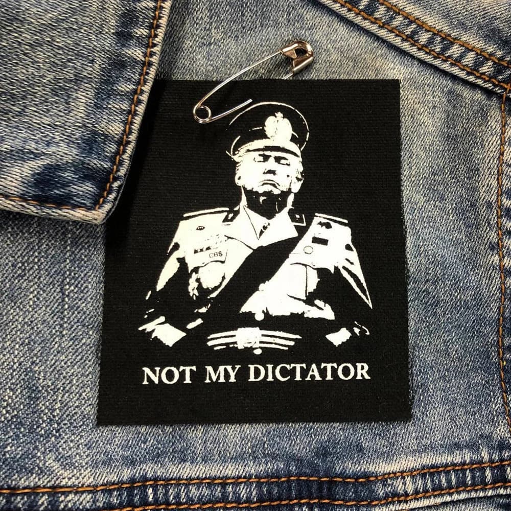 Black punk jacket patch with anti-authoritarian protest artwork reading “Not My Dictator”
