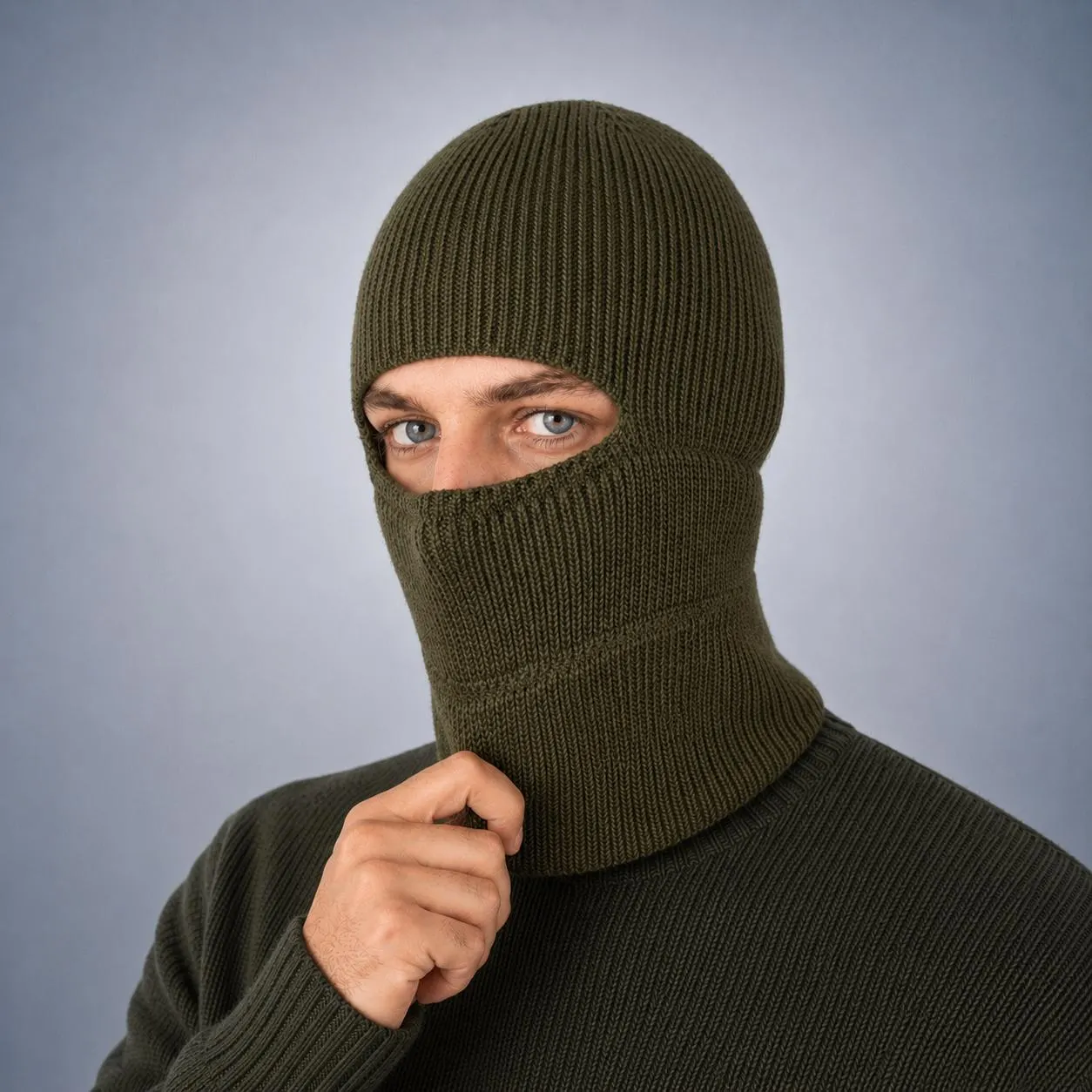 Olive green mens balaclava shown in a close portrait with the fitted knit structure