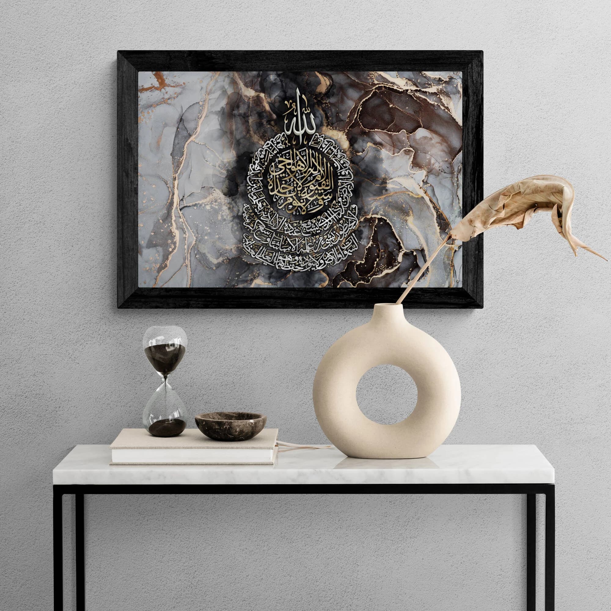 Modern Muslim home decor? Look no further! This Ayatul Kursi wall art features radiant gold and silver calligraphy set against a mesmerizing black and gold abstract background.