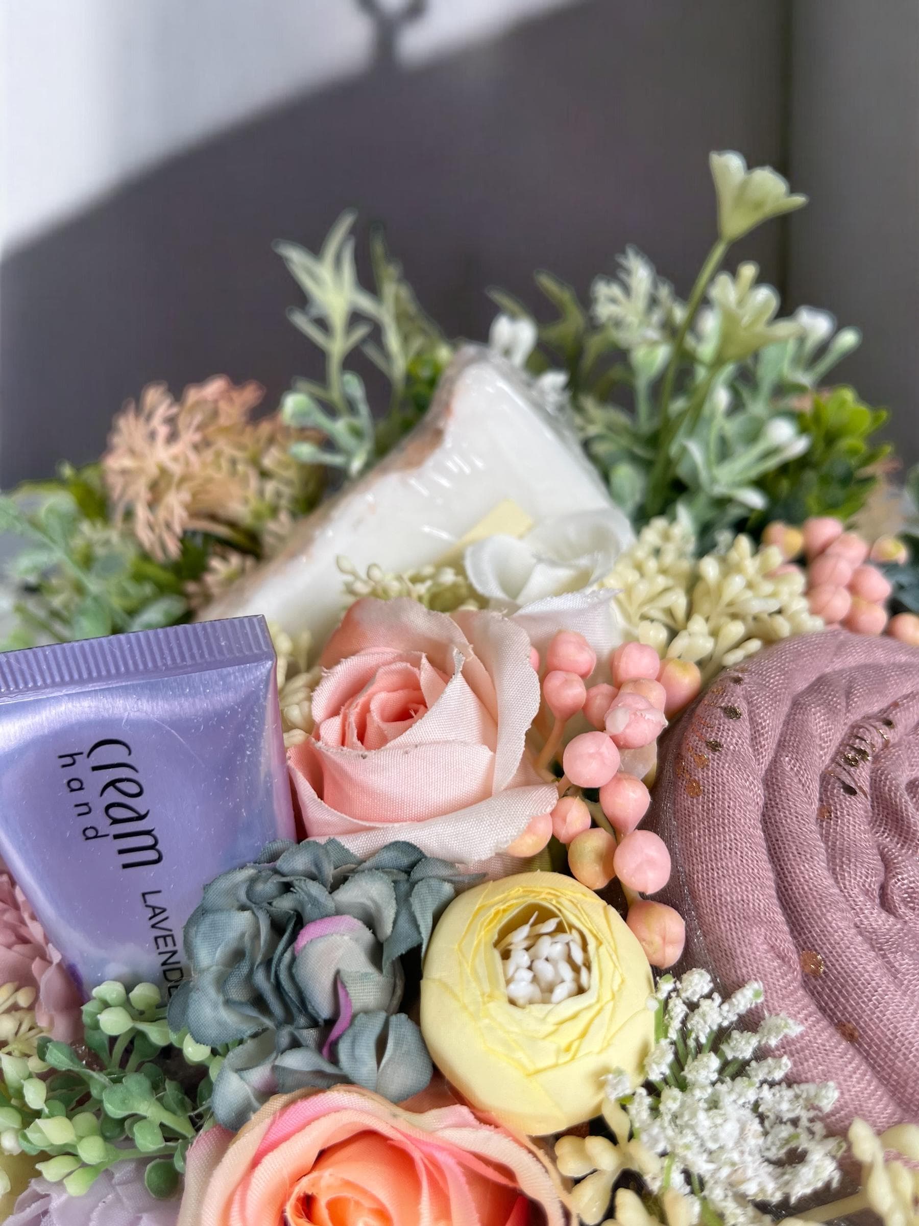 Image of soap and hand cream within floral display