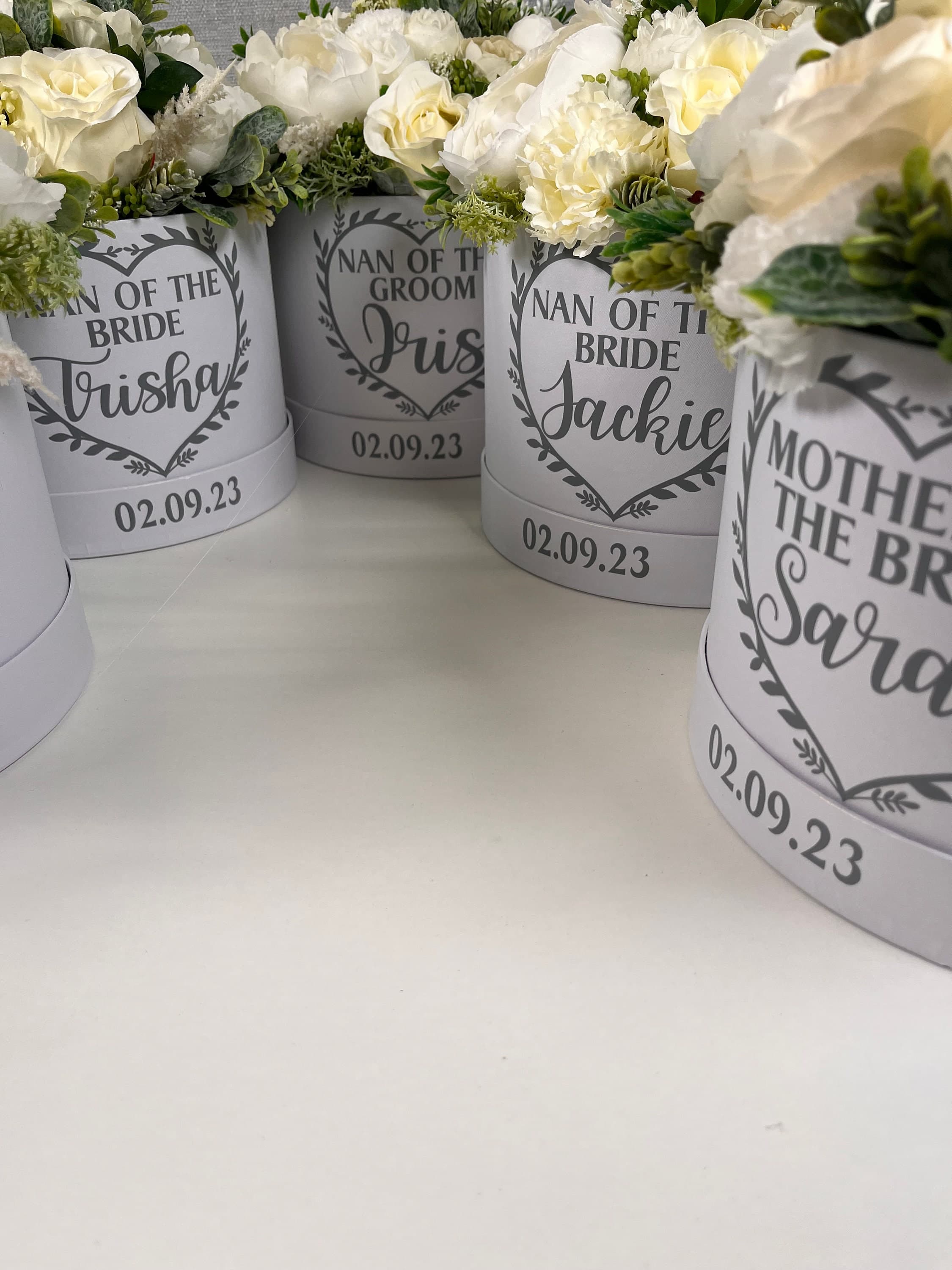 White hat box filled with flowers