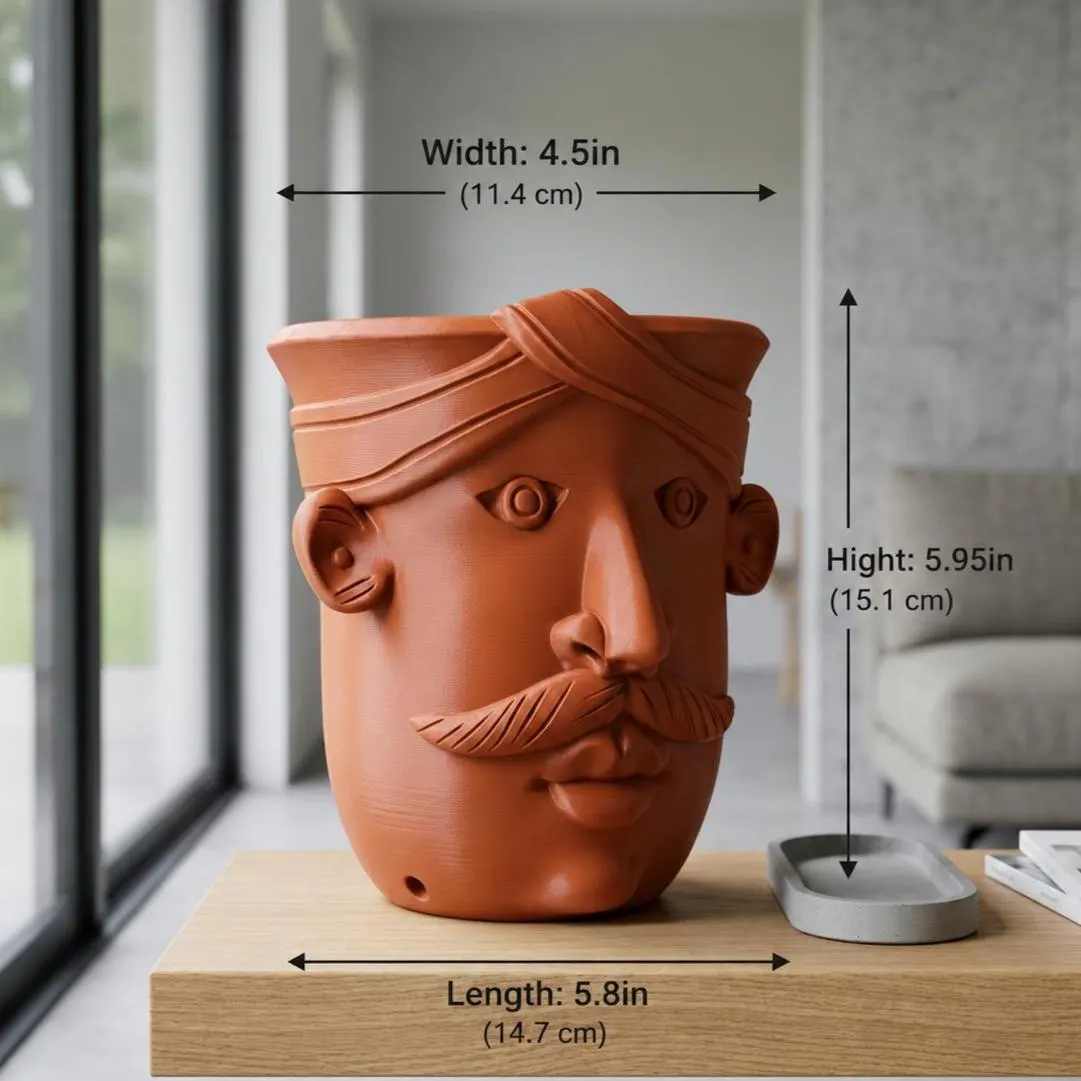 Terracotta 3D printed mustache man face planter with a sculpted headwrap, shown empty on a light wood stand by a window. Labels mark it 4.5 in wide, 5.95 in tall, and 5.8 in deep, with a drainage hole at the base.