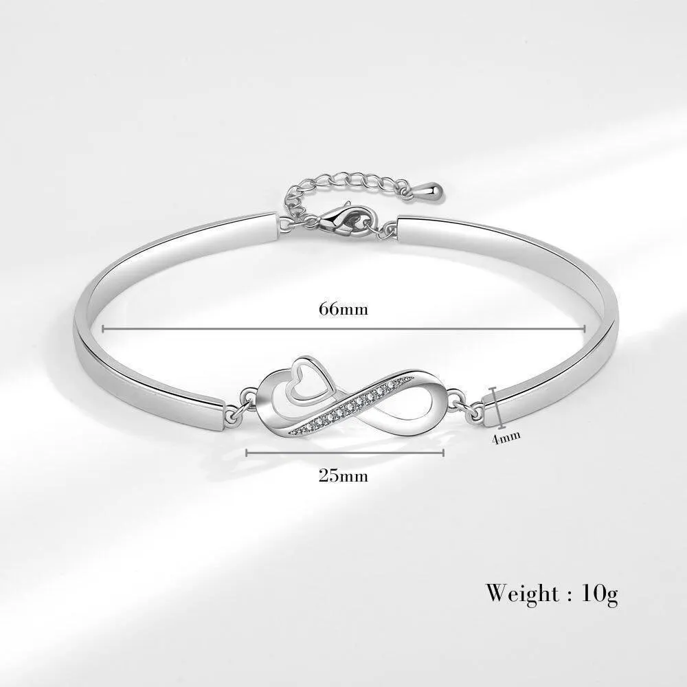 a silver bracelet with a heart and an arrow on it
