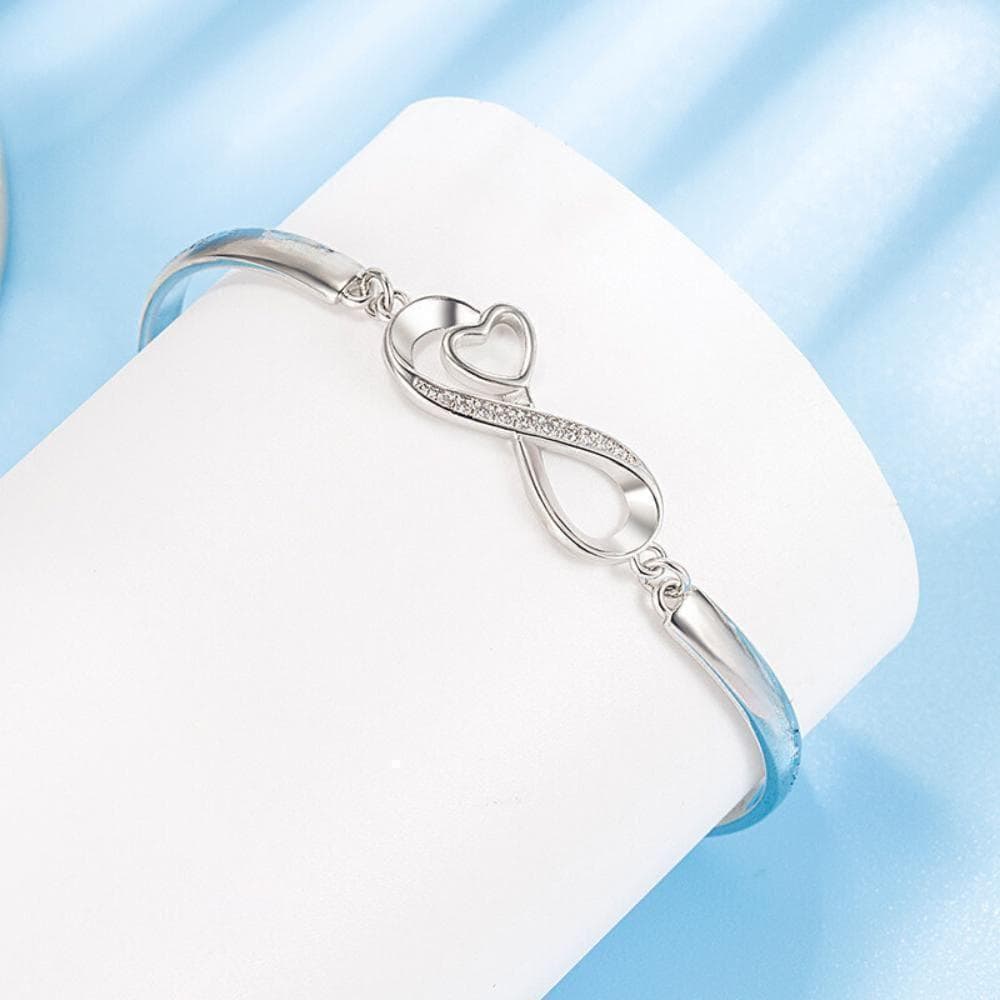 a silver bracelet with a heart on it