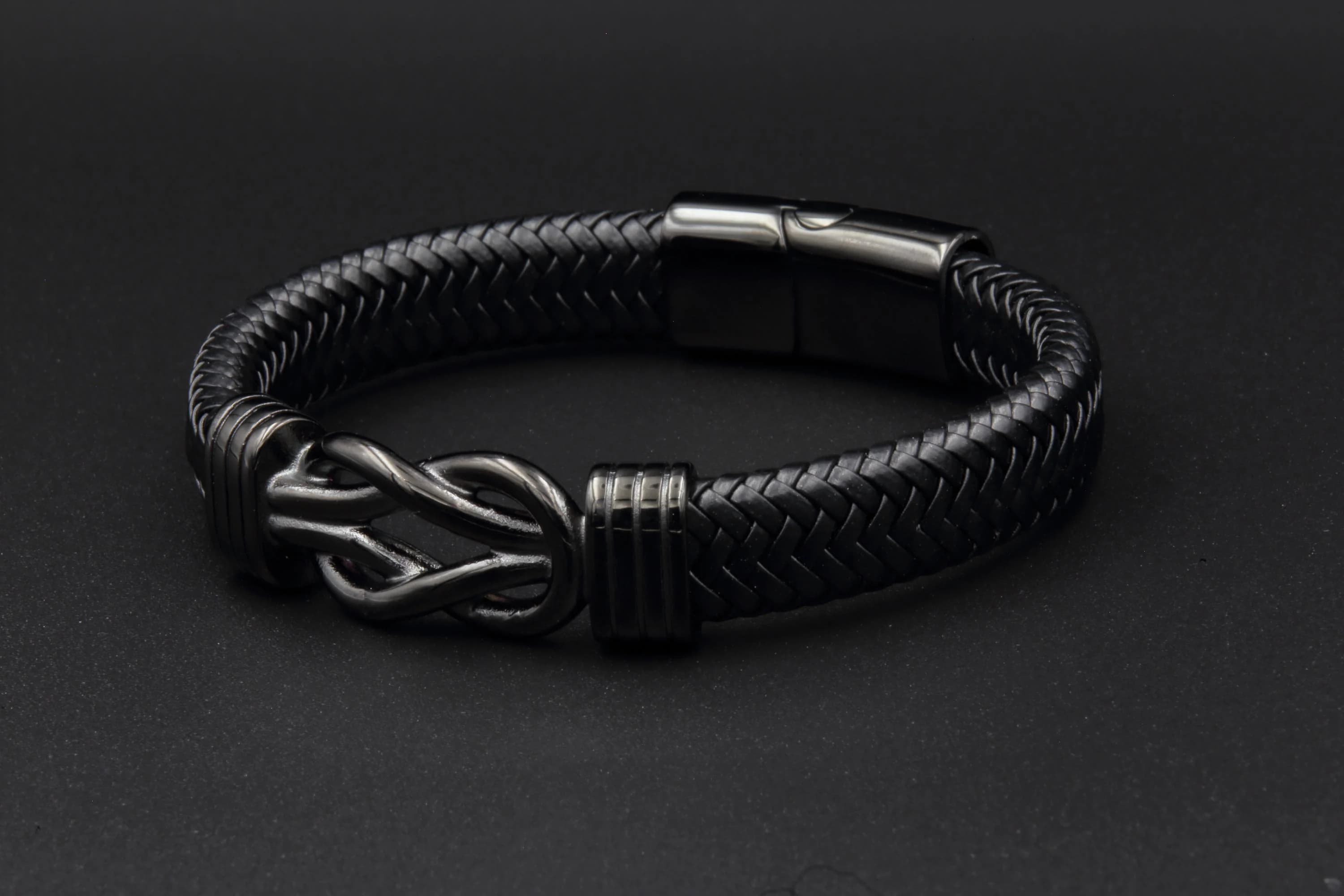 a black leather bracelet with a silver clasp