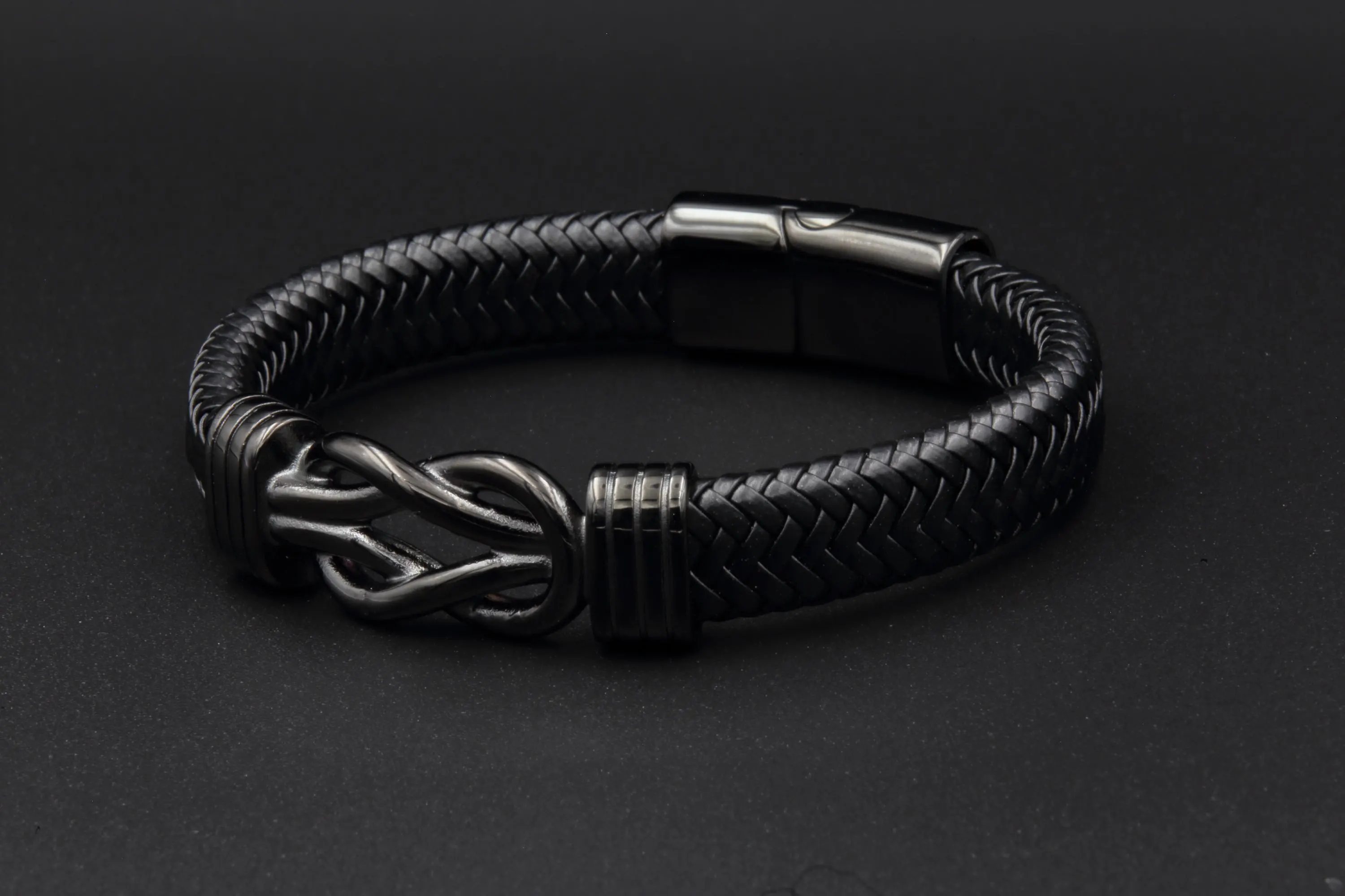 a black leather bracelet with a silver clasp