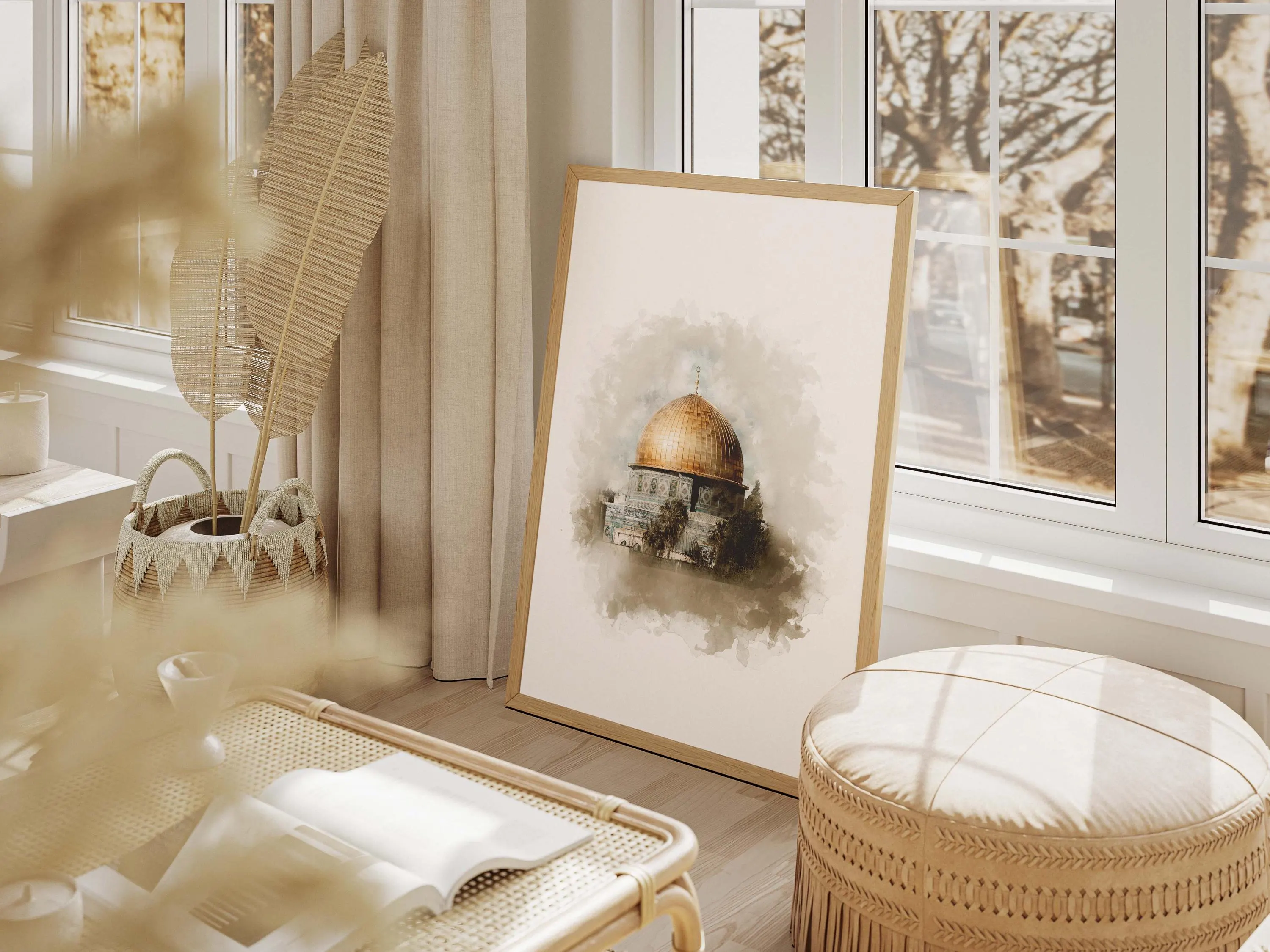 May include: A framed print featuring a watercolor painting of a building with a golden dome. The artwork is displayed in a light-filled room with a woven ottoman, a rattan bench, and a woven basket. The room has neutral tones.