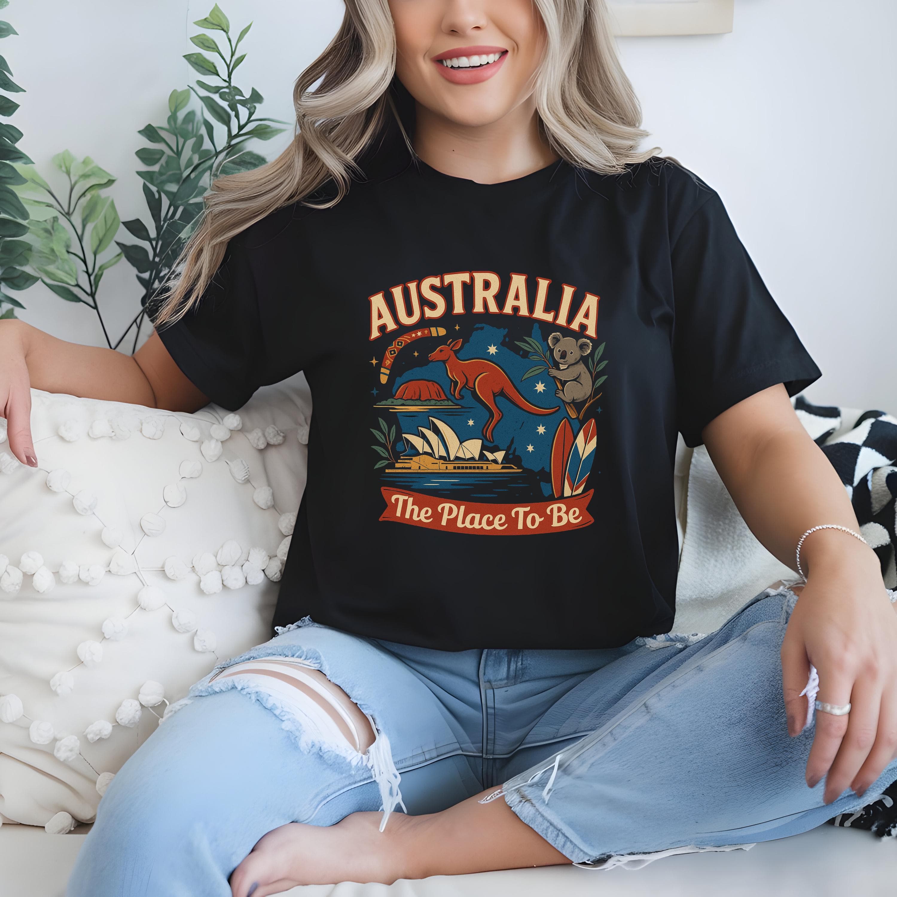 AUSTRALIA – The Place To Be!, A colorful and attractive Aussie T-shirt, from a PROUD Australian.
The bold, stylized lettering of "AUSTRALIA, The Place To Be" is surrounded by beloved Aussie icons. From the hopping kangaroo and cuddly koala 🐨 to the majestic Sydney Opera House, the legendary Uluru, surfboards by the beach 🏄♀️, eucalyptus leaves, and the trusty boomerang, making it a perfect Aussie Gift.
This beautiful t-shirt is available in multiple attractive colors and sizes from XS to 5XL.