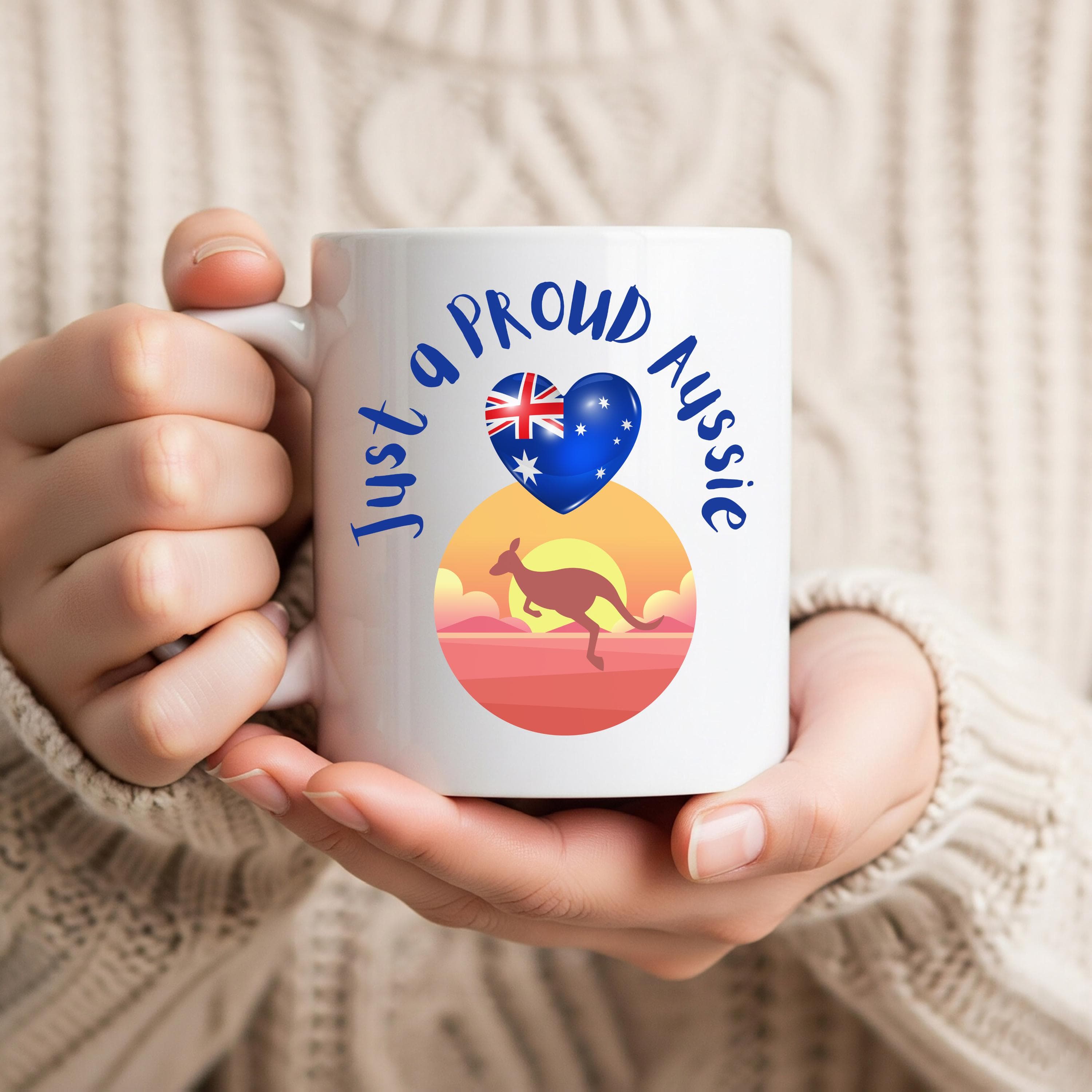 May include: White ceramic mug with the text "Just a proud Aussie" in blue script. The mug features a heart with the Australian flag and a kangaroo silhouette against a sunset backdrop. A perfect gift for anyone who loves Australia.