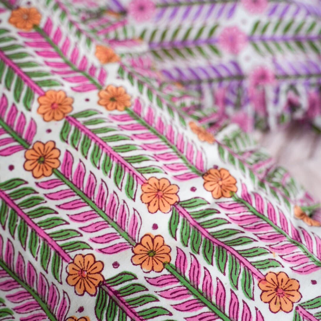 Handcrafted cushion adorned with intricate hand block prints in a lively bohemian style, bursting with an array of vibrant and colorful hues