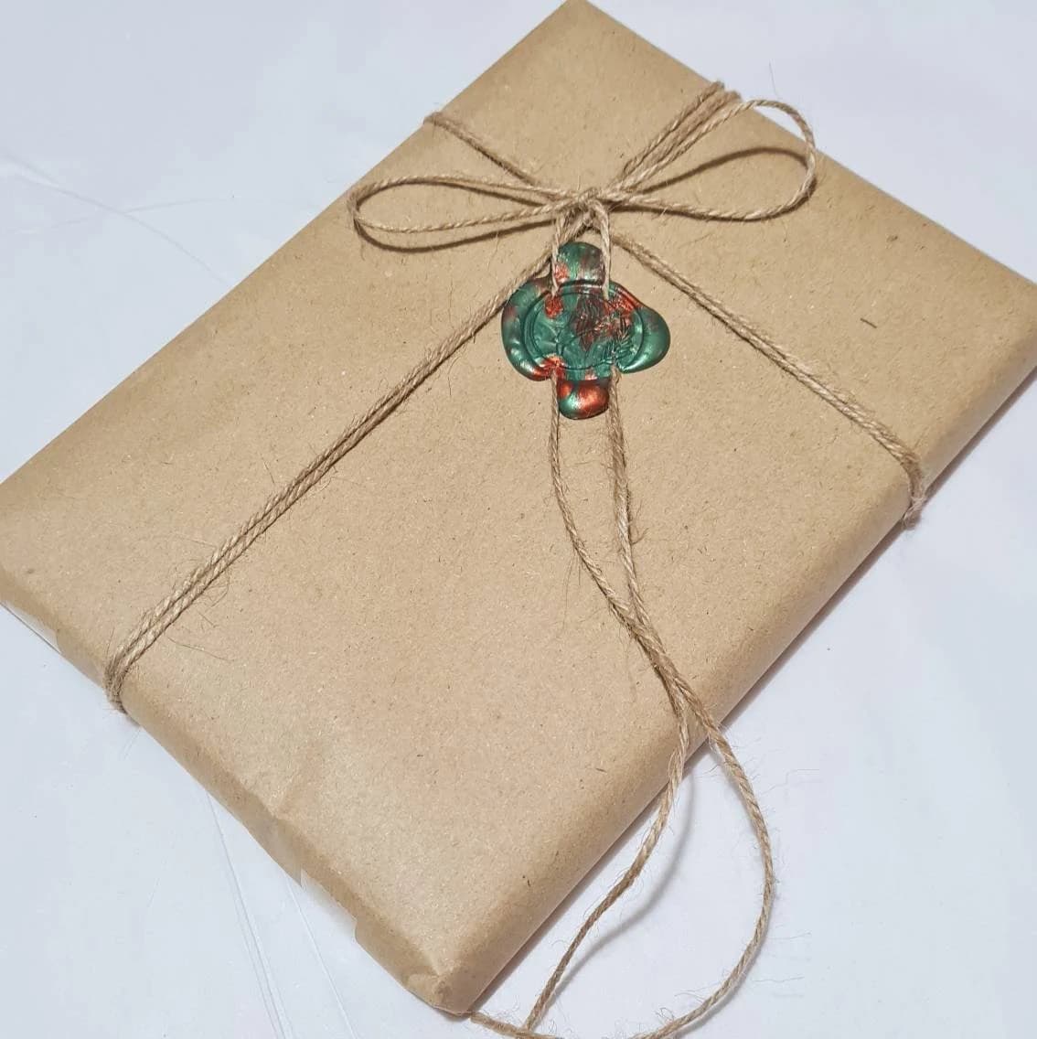 Luxury gift wrap available, consisting of brown paper, twine and wax seal.