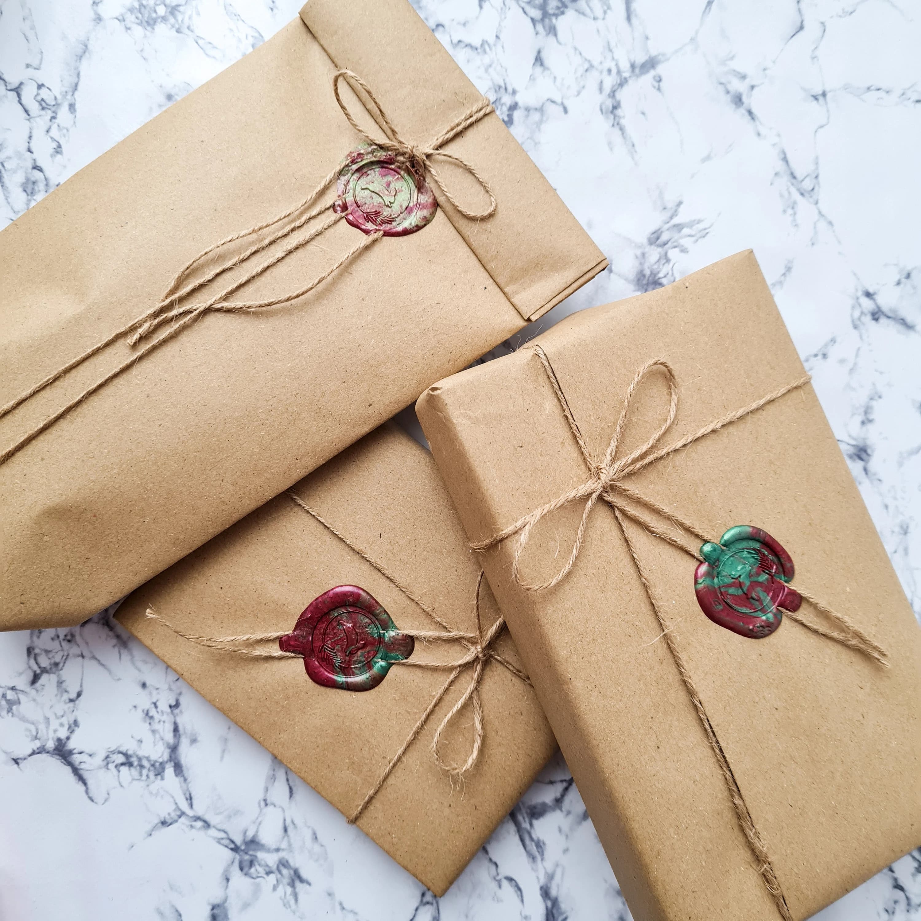 The picture describes the luxury gift wrap available, consisting of brown paper, twine and wax seal.