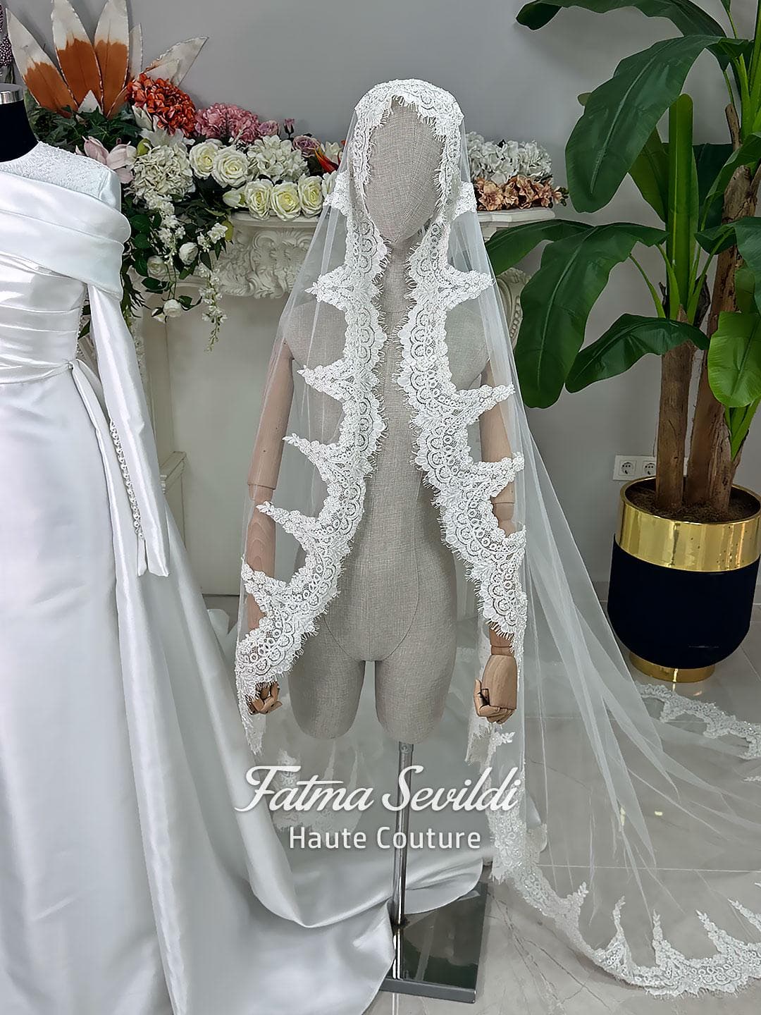 Luxury satin hijab wedding dress with off-shoulder long sleeves and an A-line silhouette, shown with premium lace veil and dramatic train. Custom couture modest bridal gown design with elegant draping and pearl details.
