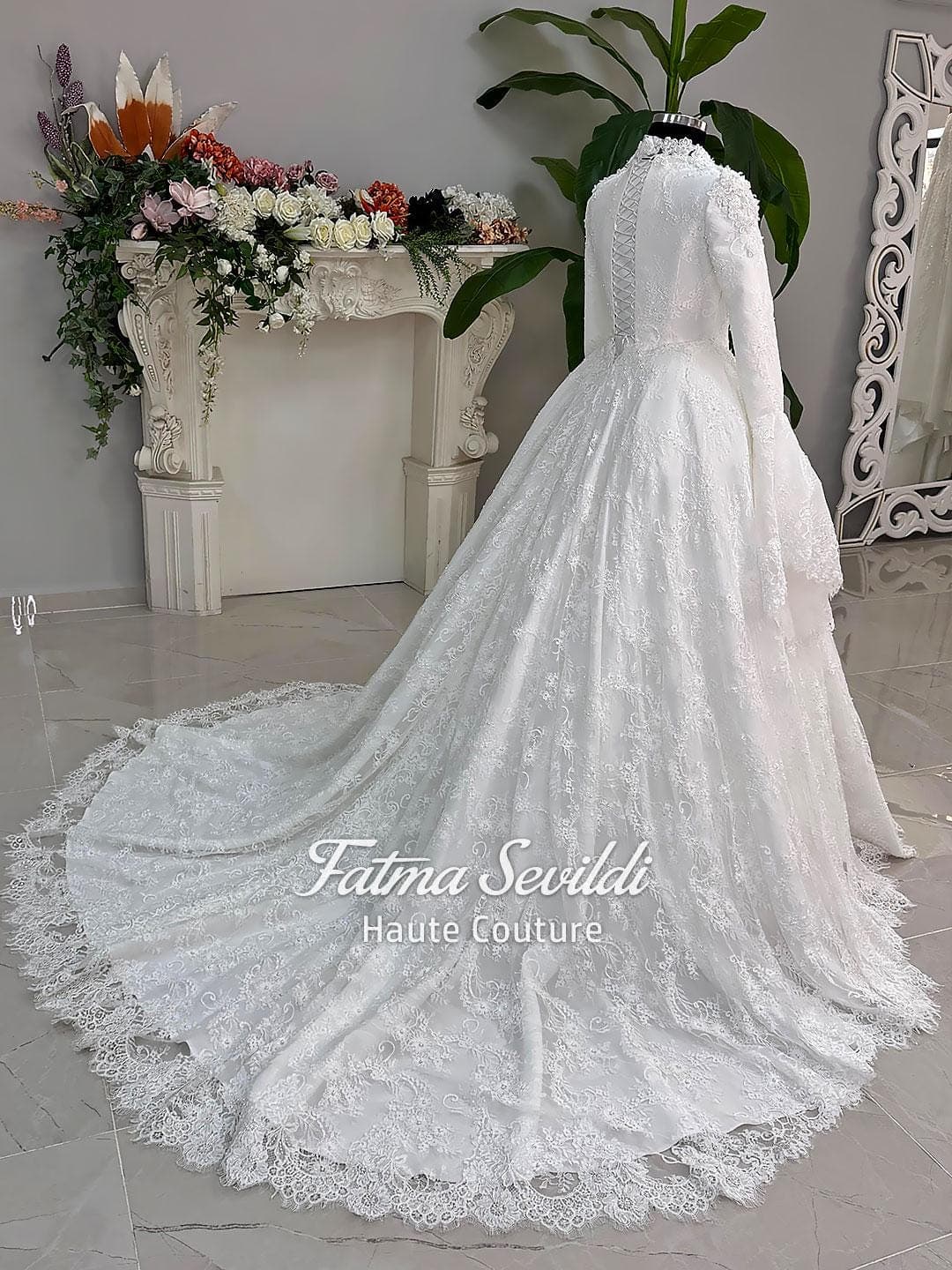 Luxury hijab wedding dress with long sleeves and high neckline, featuring beaded lace over a full ballgown silhouette and matching veiled bridal set. Couture modest bridal gown handmade in Türkiye.
