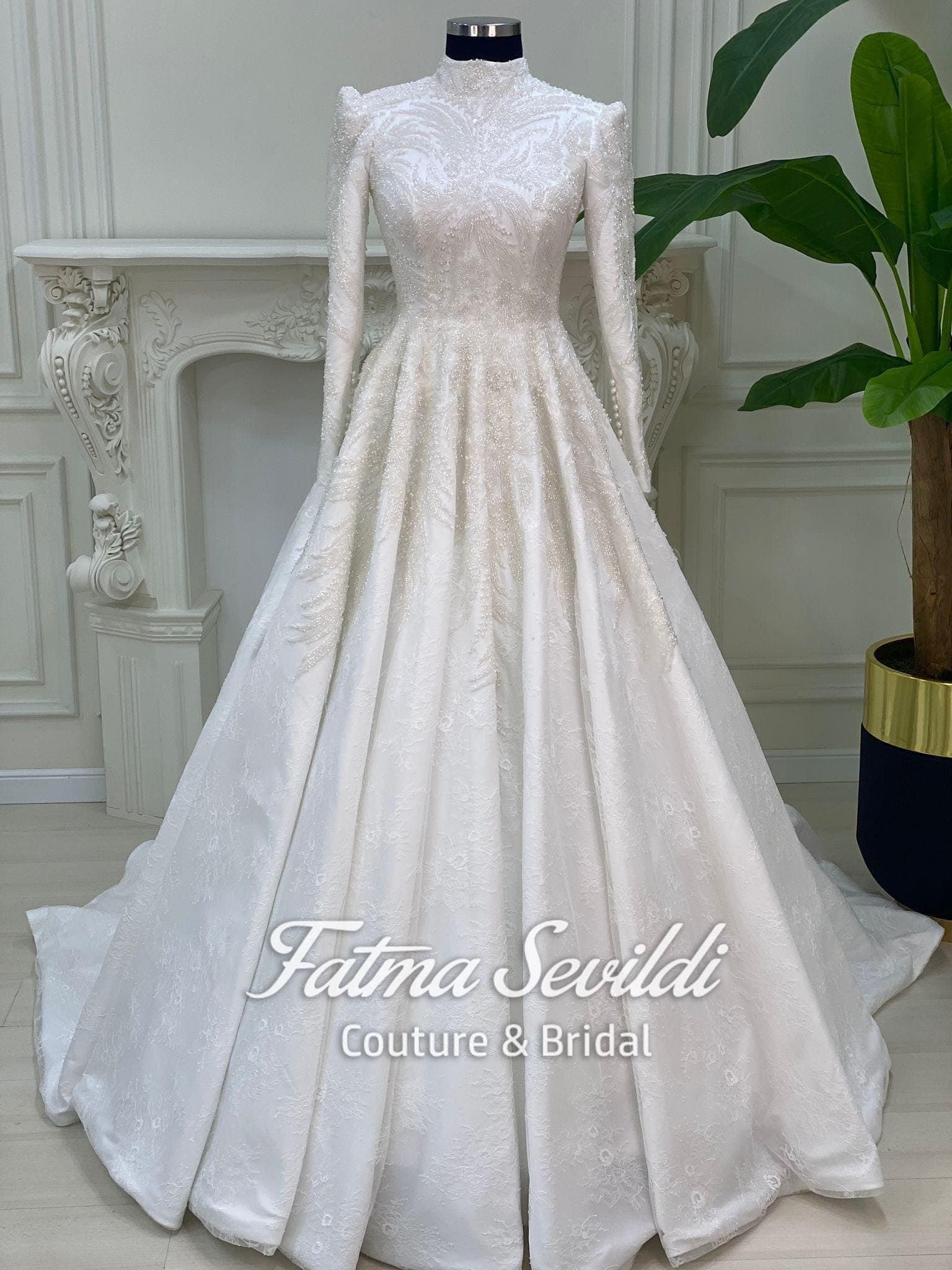 Veiled hijab wedding dress in a beaded lace ballgown silhouette with high neck and long sleeves, made to measure with included lace veil.