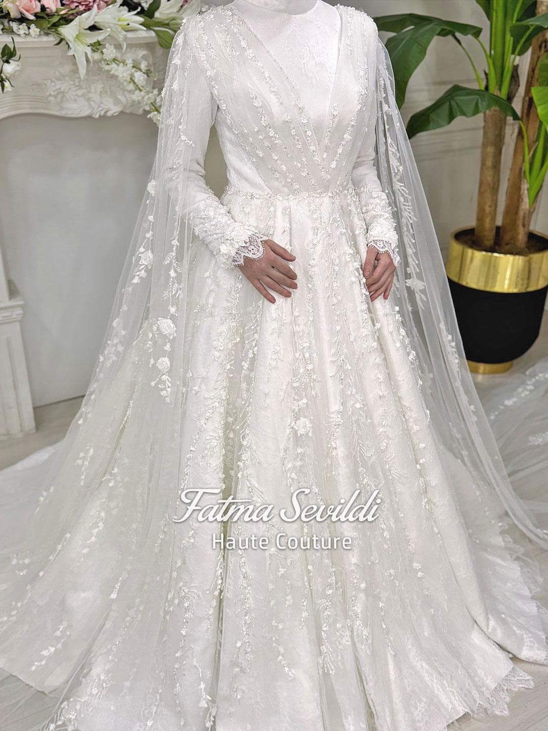 Veiled hijab wedding dress with floral lace, long sleeves and a modest A-line silhouette, handcrafted for a luxury muslim bridal look. Includes a matching premium lace veil for an elegant full-coverage finish.