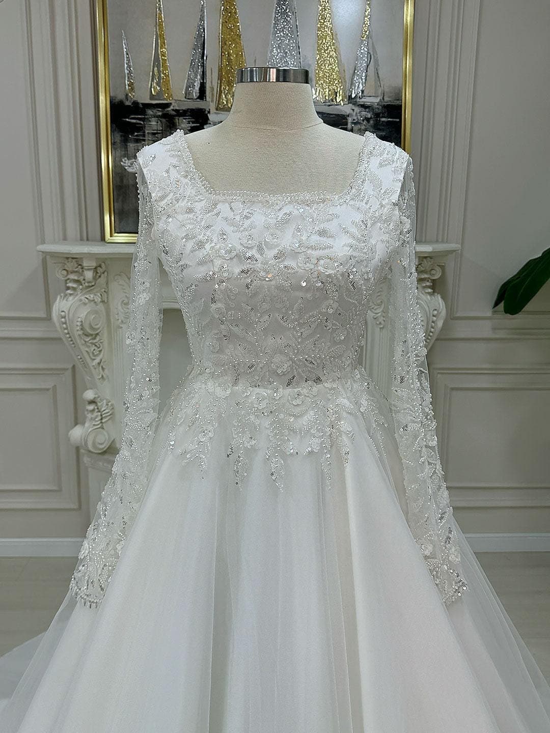 Veiled hijab wedding dress with square neckline and long beaded lace sleeves, an elegant A-line modest bridal gown with included lace veil.