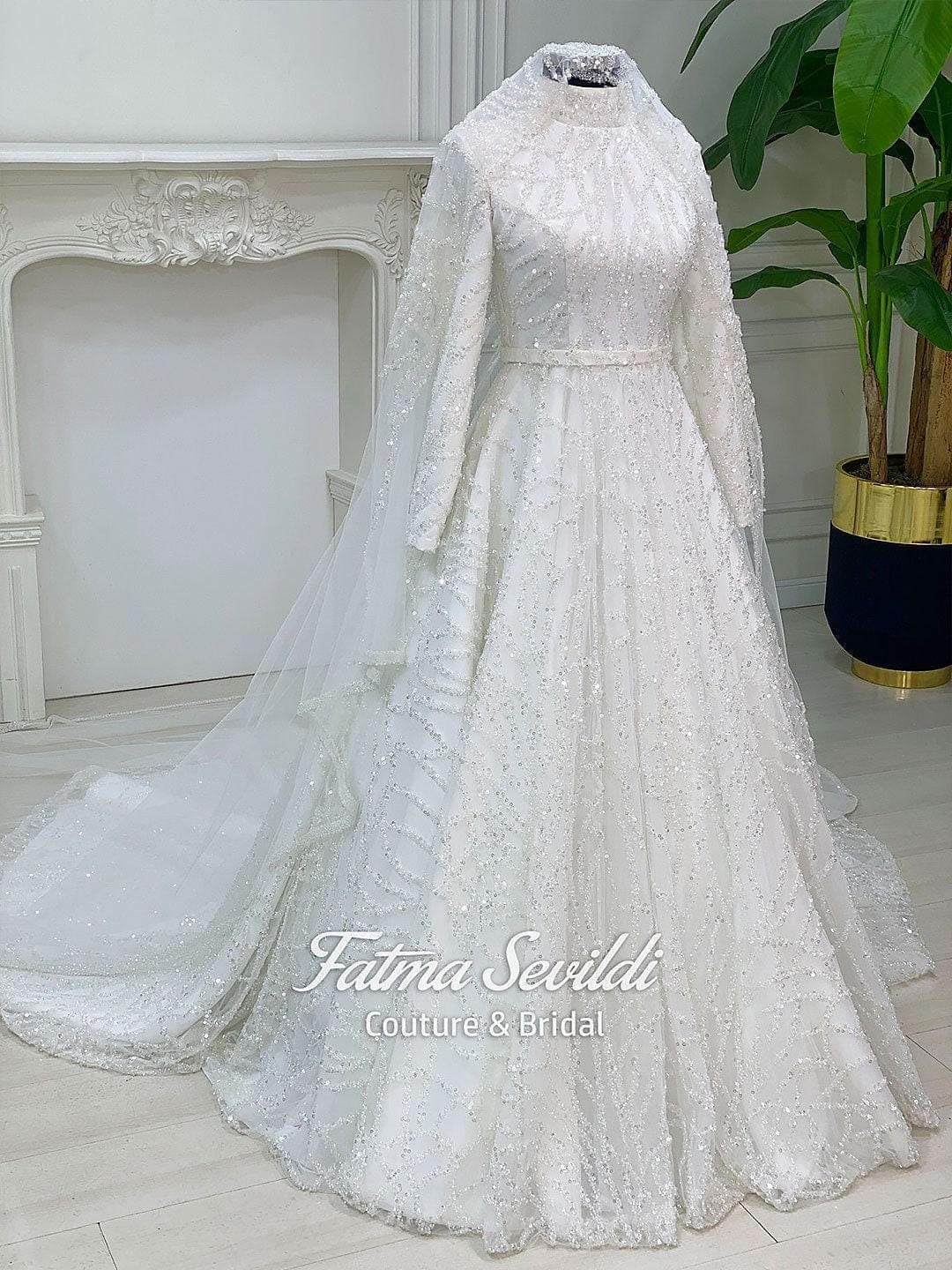 Veiled hijab wedding dress in full beaded lace with high neck and long sleeves, a modest ballgown bridal set including a premium lace veil.