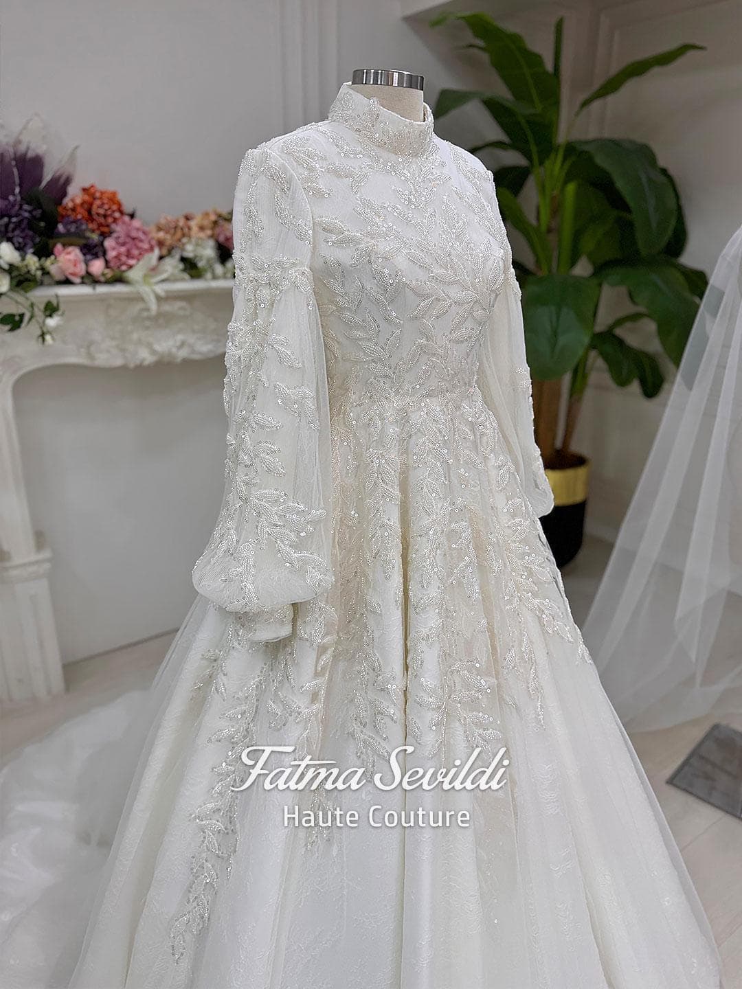 Veiled hijab wedding dress in a couture ballgown silhouette with high neck, long sleeves, and shimmering beaded lace, made to measure.