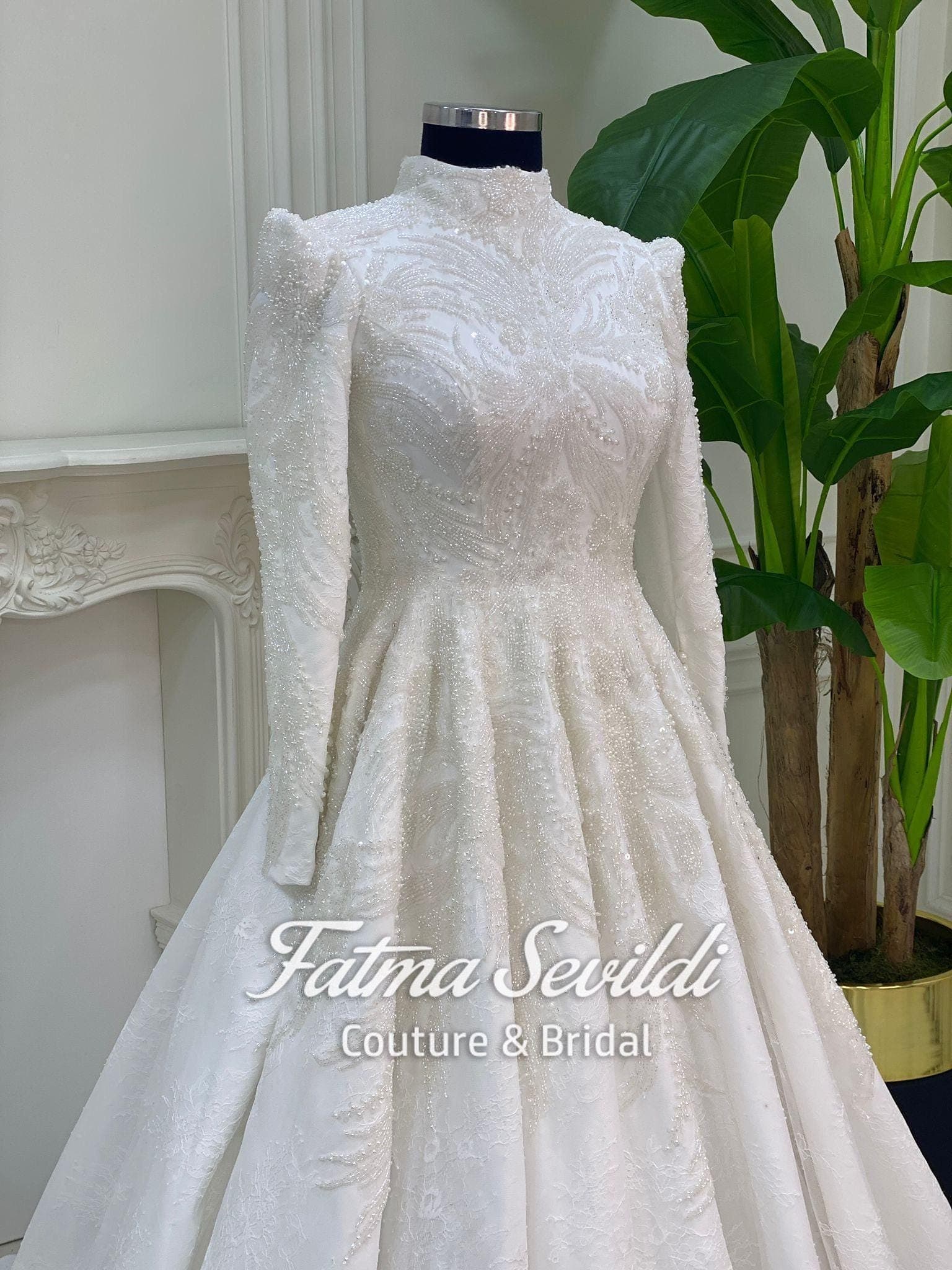 Veiled hijab wedding dress in a beaded lace ballgown silhouette with high neck and long sleeves, made to measure with included lace veil.