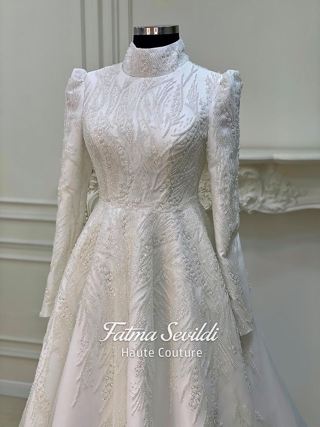 Luxury hijab wedding dress with high neck and long sleeves, featuring elegant beaded lace over a satin A-line silhouette for a modest bridal look.