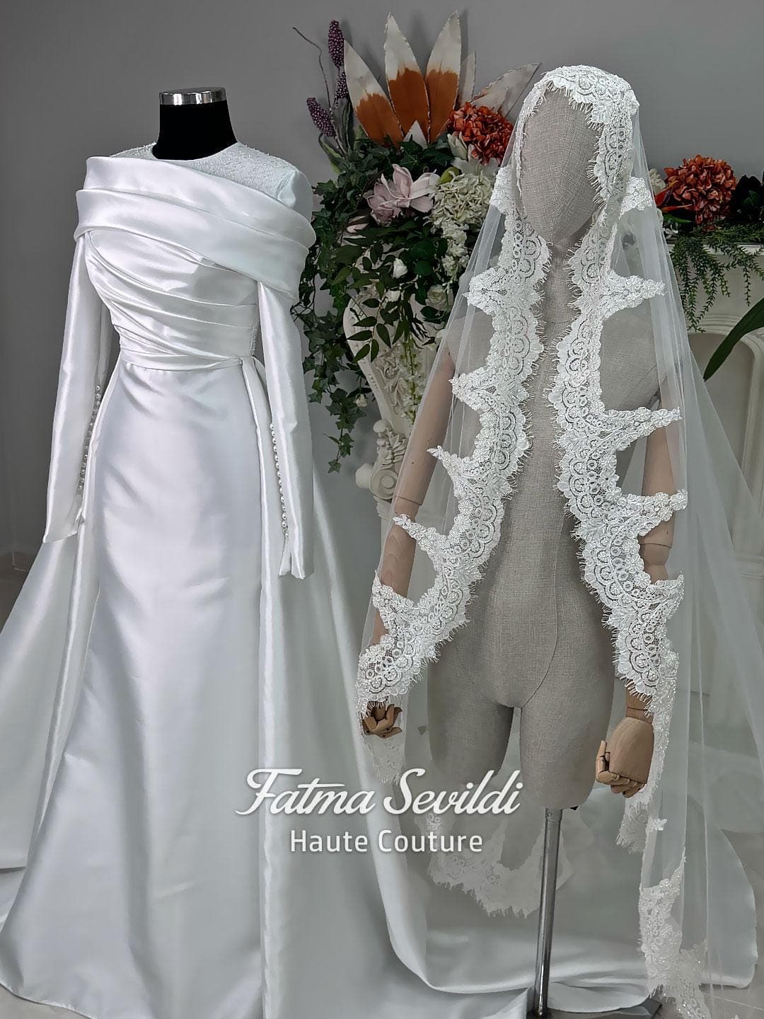 Luxury satin hijab wedding dress with off-shoulder long sleeves and an A-line silhouette, shown with premium lace veil and dramatic train. Custom couture modest bridal gown design with elegant draping and pearl details.