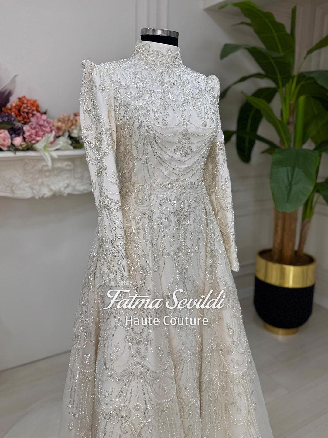 Luxury veiled hijab wedding dress with high neck, long sleeves, and hand-beaded lace in an elegant A-line silhouette. Includes premium lace veil for a complete modest bridal look.