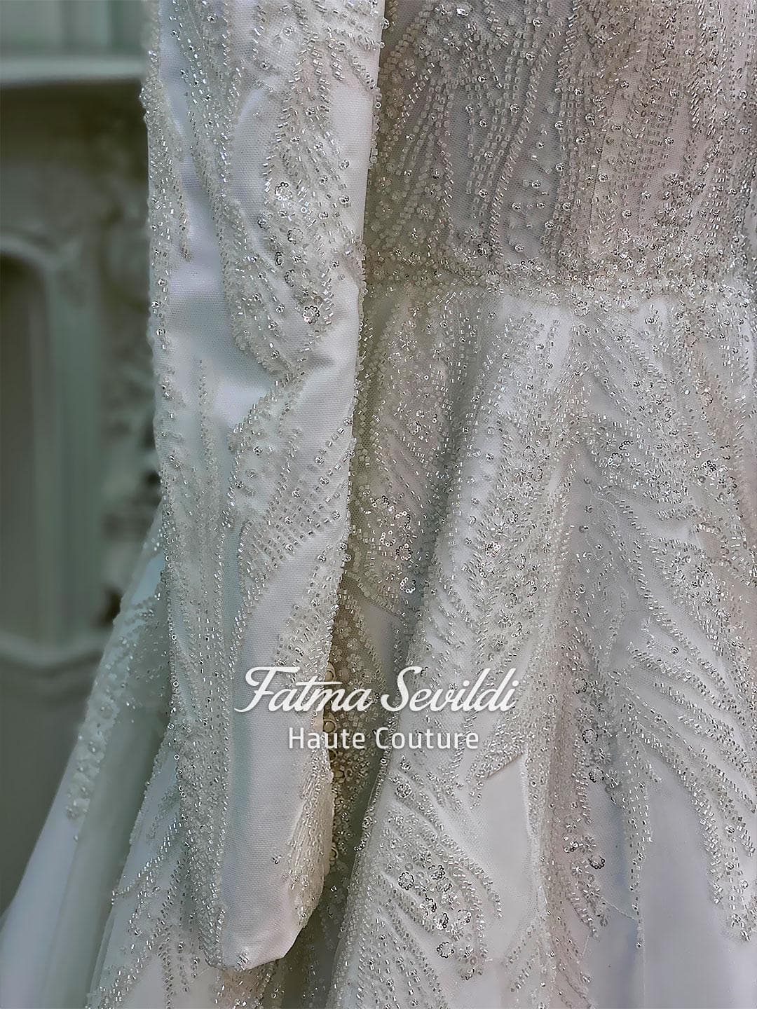 Luxury hijab wedding dress with high neck and long sleeves, featuring elegant beaded lace over a satin A-line silhouette for a modest bridal look.