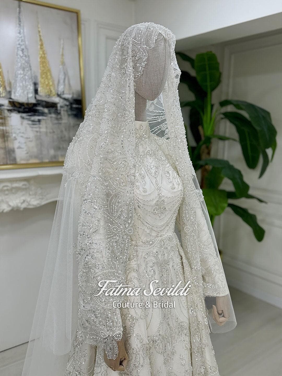 Luxury veiled hijab wedding dress with high neck, long sleeves, and hand-beaded lace in an elegant A-line silhouette. Includes premium lace veil for a complete modest bridal look.