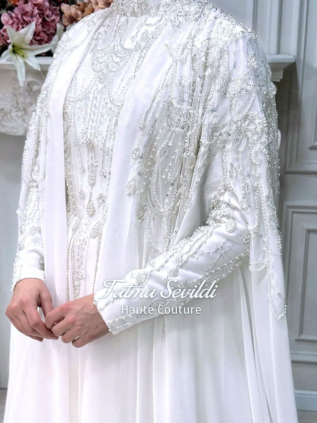 Minimal satin hijab wedding dress with long cape and long sleeves, custom made for a luxury modest bridal look. Full coverage silhouette with elegant drape for modern Muslim brides.