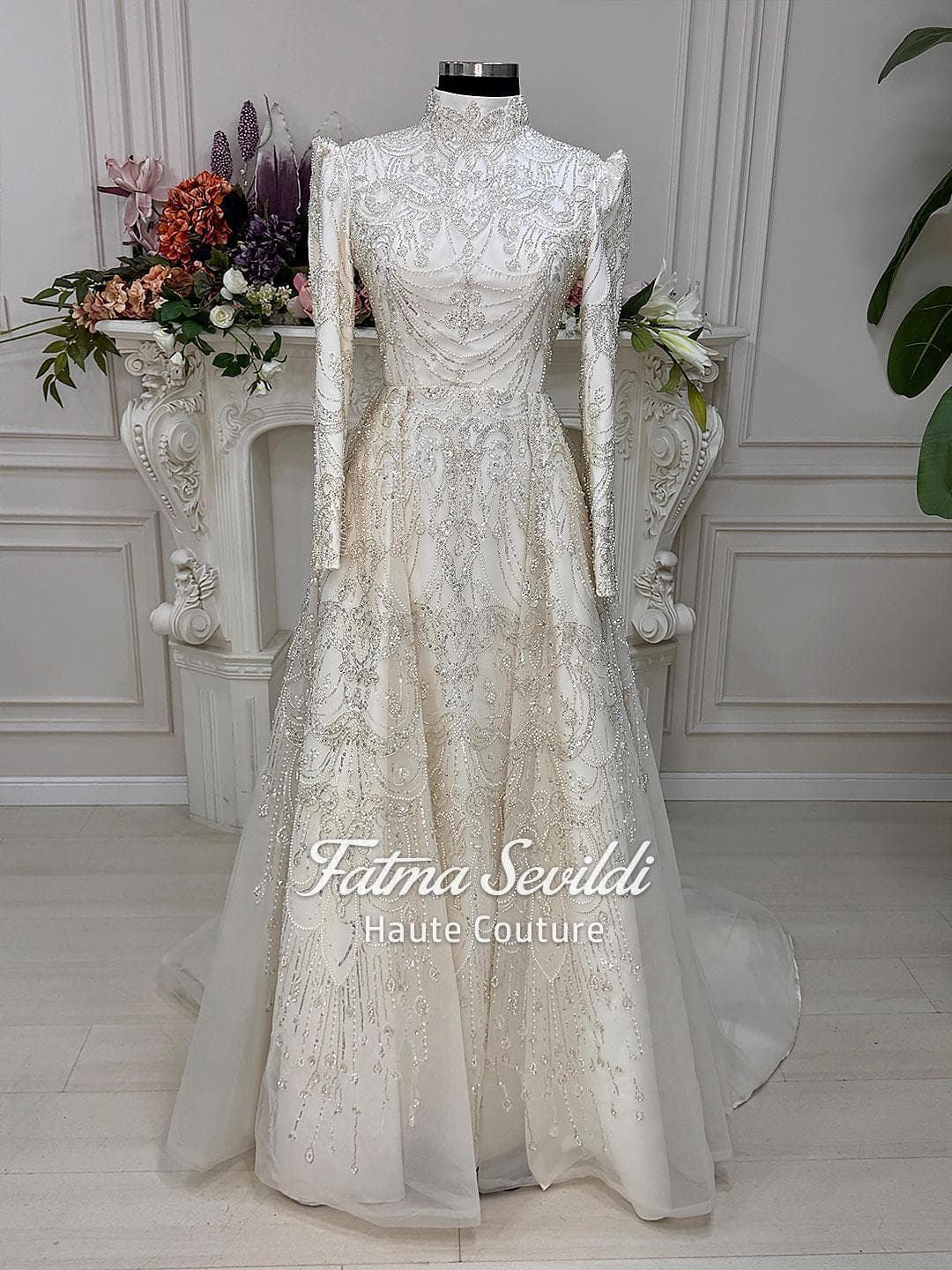 Luxury veiled hijab wedding dress with high neck, long sleeves, and hand-beaded lace in an elegant A-line silhouette. Includes premium lace veil for a complete modest bridal look.