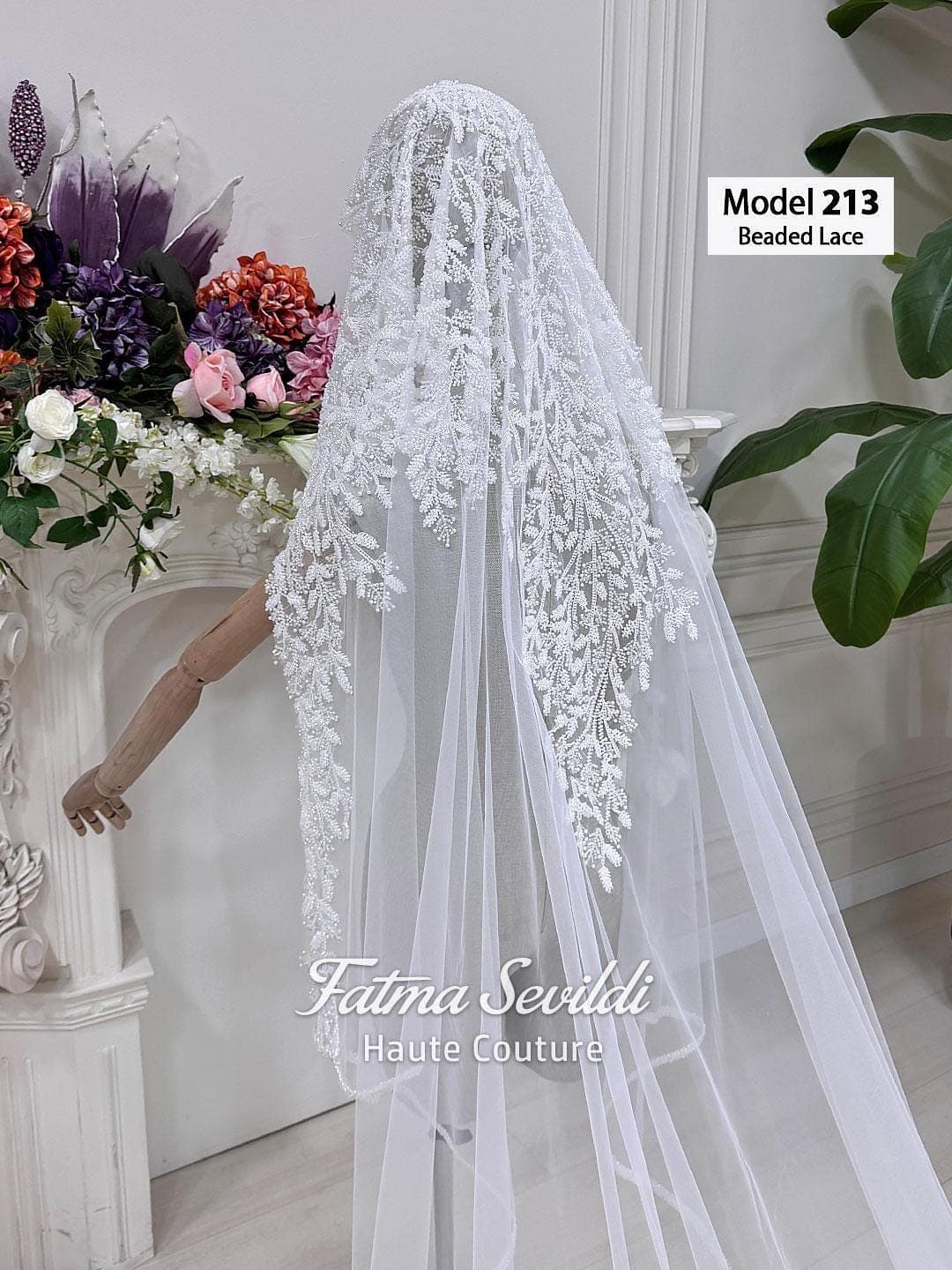 Hand-beaded lace cathedral bridal veil in soft ivory tulle, styled for elegant modest bridal wear with a hijab-friendly option. Long lace edge wedding veil with romantic drape and couture bridal detail.