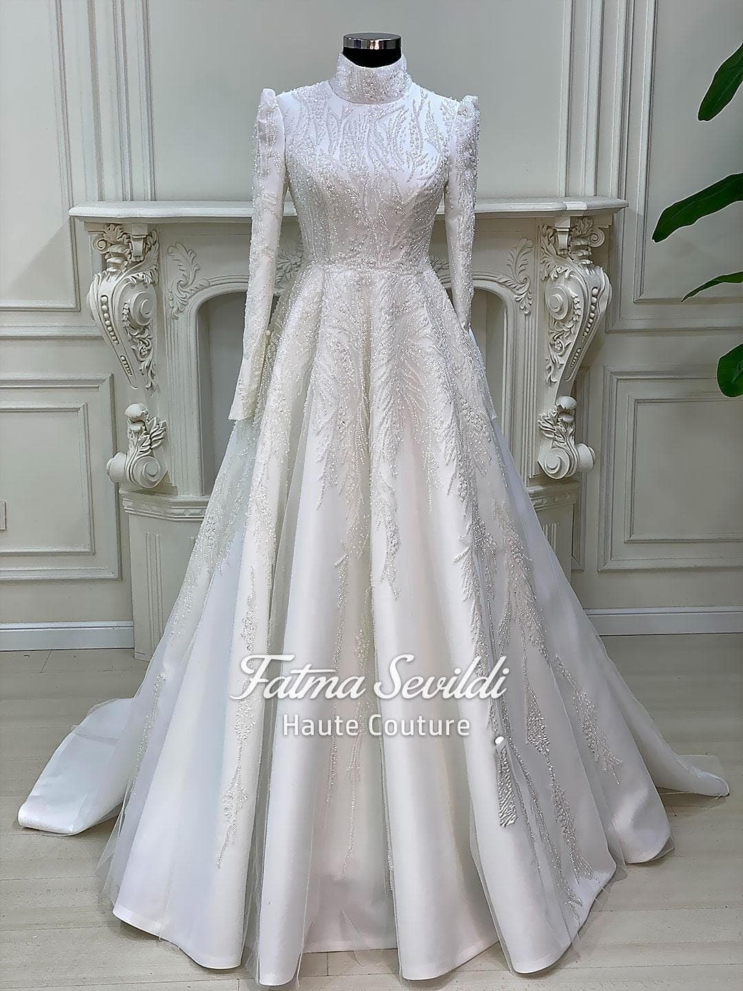 Luxury hijab wedding dress with high neck and long sleeves, featuring elegant beaded lace over a satin A-line silhouette for a modest bridal look.