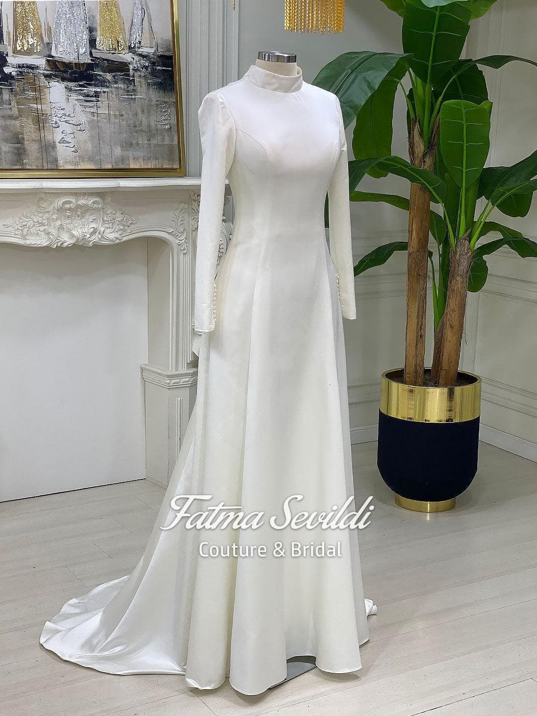 Veiled satin hijab wedding dress with high neck, long sleeves, and a clean A-line silhouette. Includes a premium lace-edge cathedral veil for an elegant modest bridal look.