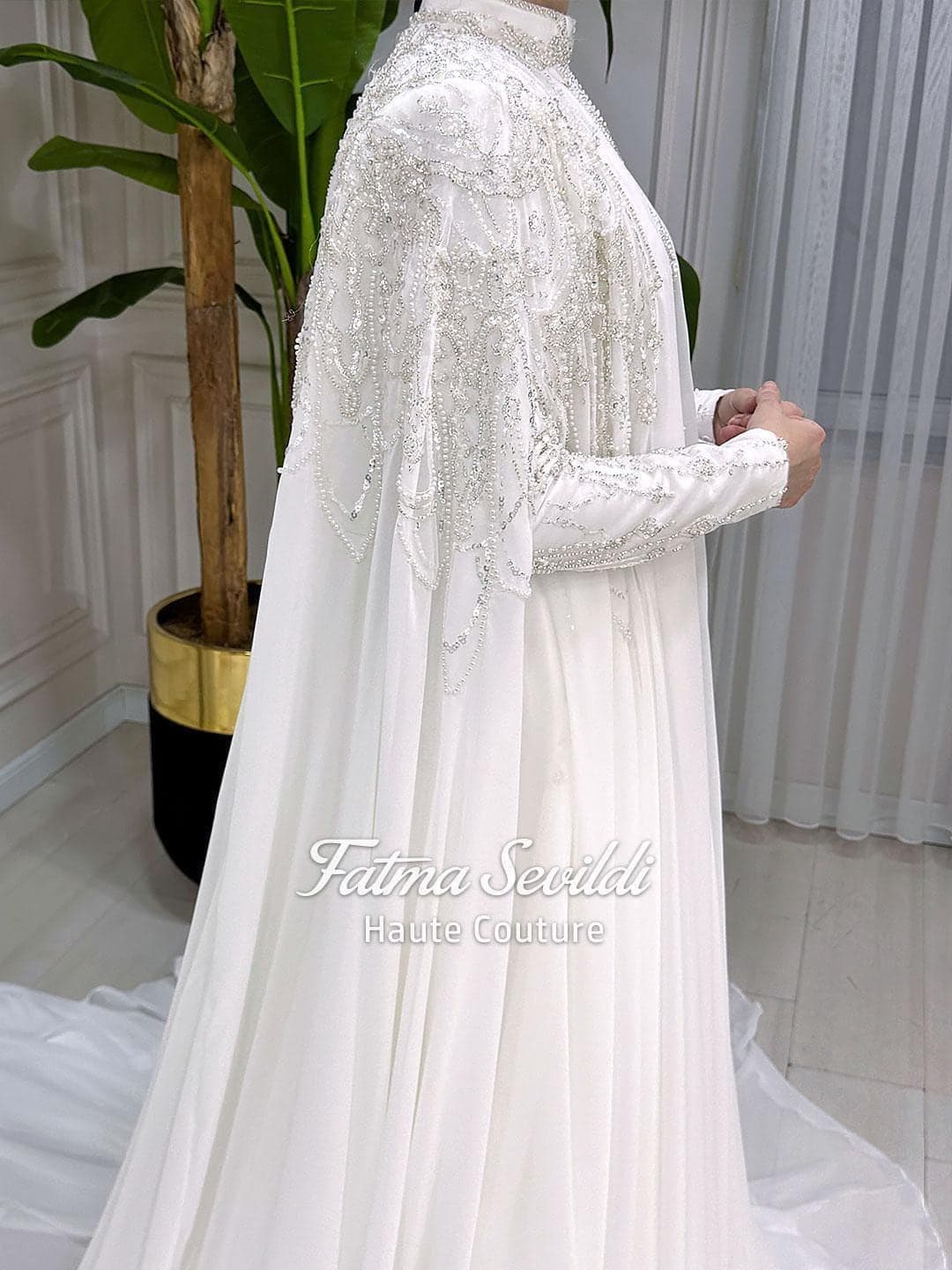 Minimal satin hijab wedding dress with long cape and long sleeves, custom made for a luxury modest bridal look. Full coverage silhouette with elegant drape for modern Muslim brides.