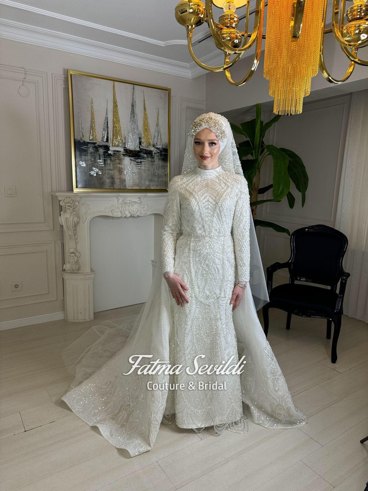 Luxury veiled hijab wedding dress with high neck, long sleeves, and hand-finished beaded lace in an A-line ballgown silhouette. Premium lace-edge veil included for a complete modest bridal look.