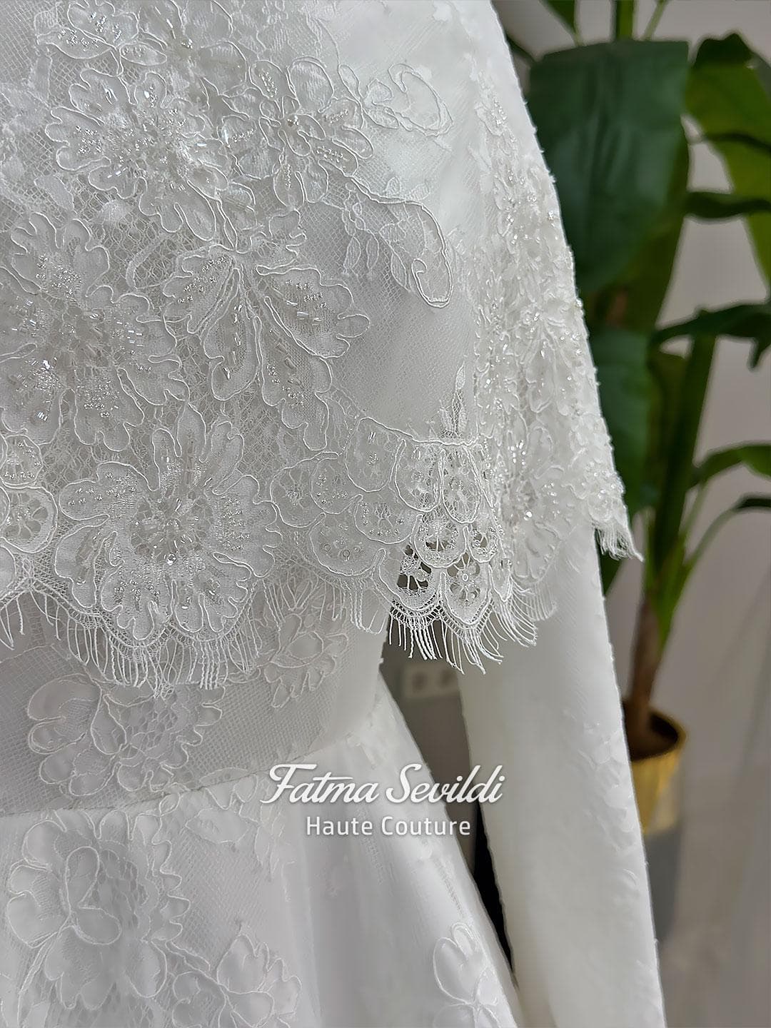 Elegant hijab wedding dress with long sleeves, high neck, detachable lace cape, cathedral train, and premium lace veil included. Luxury modest bridal couture gown in white with floral lace detailing.