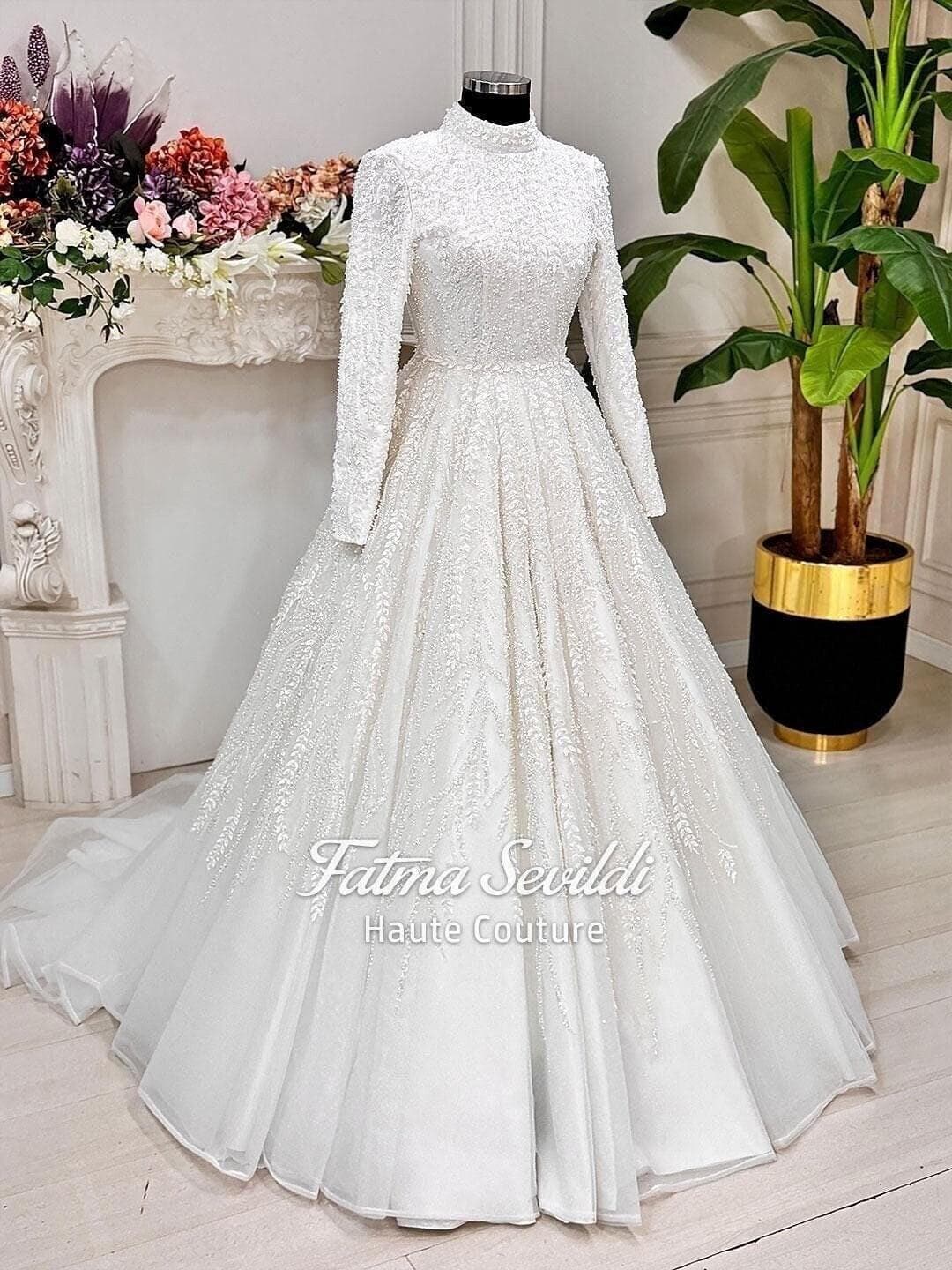Veiled hijab wedding dress with full beaded lace, high neck and long sleeves in a luxury modest ballgown silhouette, made to measure. Includes a matching premium lace veil for a complete Muslim bridal set.