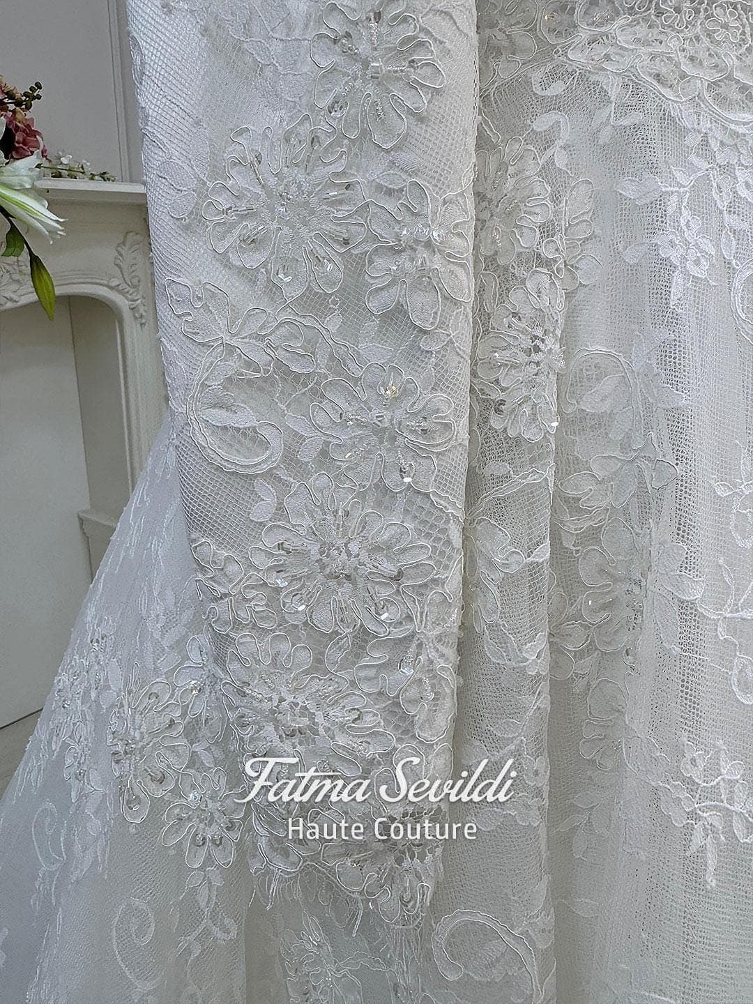 Veiled hijab wedding dress with high neck, long sleeves, and shimmering beaded lace over satin with a full skirt. Includes petticoat, headscarf, and a lace edge veil for a complete modest bridal set.