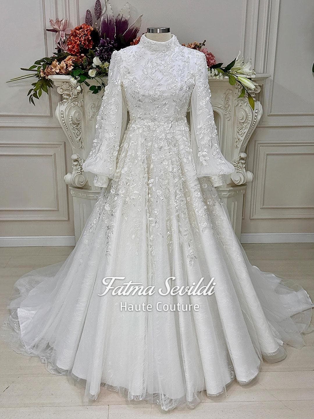 Veiled hijab wedding dress with high neck, long sleeves, and luxury beaded lace in a couture ball gown silhouette. Includes premium lace veil, headscarf, and petticoat.