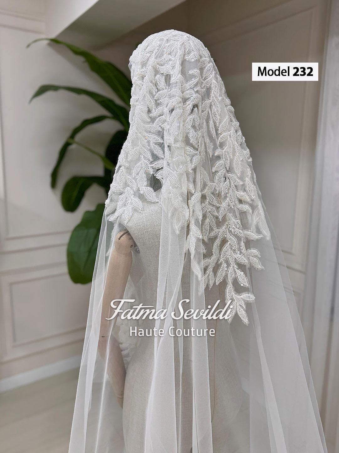 Veiled hijab wedding dress in a couture ballgown silhouette with high neck, long sleeves, and shimmering beaded lace, made to measure.