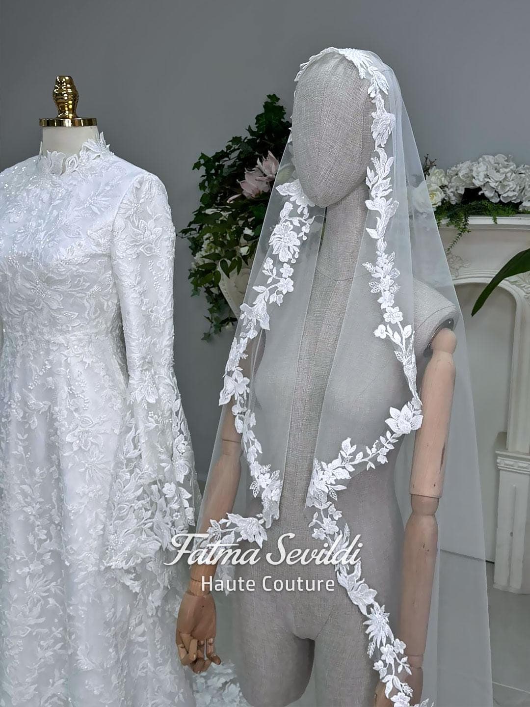 Veiled hijab wedding dress with high neck, long sleeves, and beaded floral lace in an elegant A-line couture silhouette.