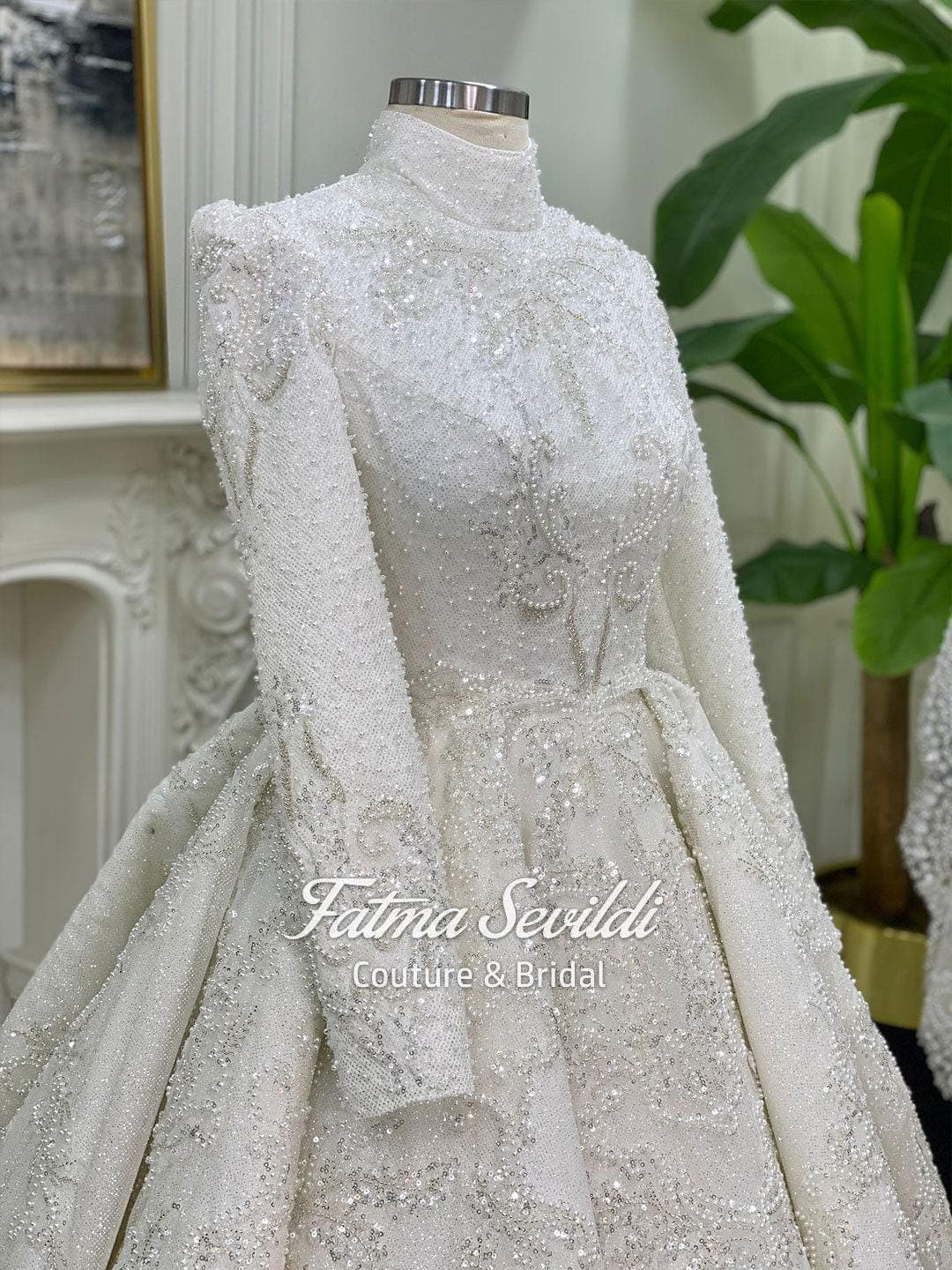 Veiled hijab wedding dress in a modest ballgown silhouette with high neck, long sleeves, and hand-beaded lace sparkle, including a premium lace veil.