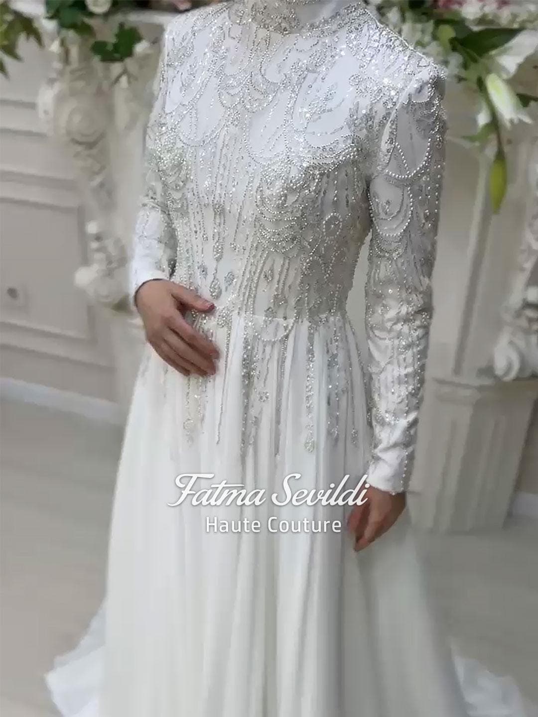 Luxury hijab wedding dress with beaded lace, high neck and long sleeves in a modest A-line silhouette, custom made for elegant Muslim bridal coverage. Sparkling couture beadwork on satin and tulle for a refined finish.
