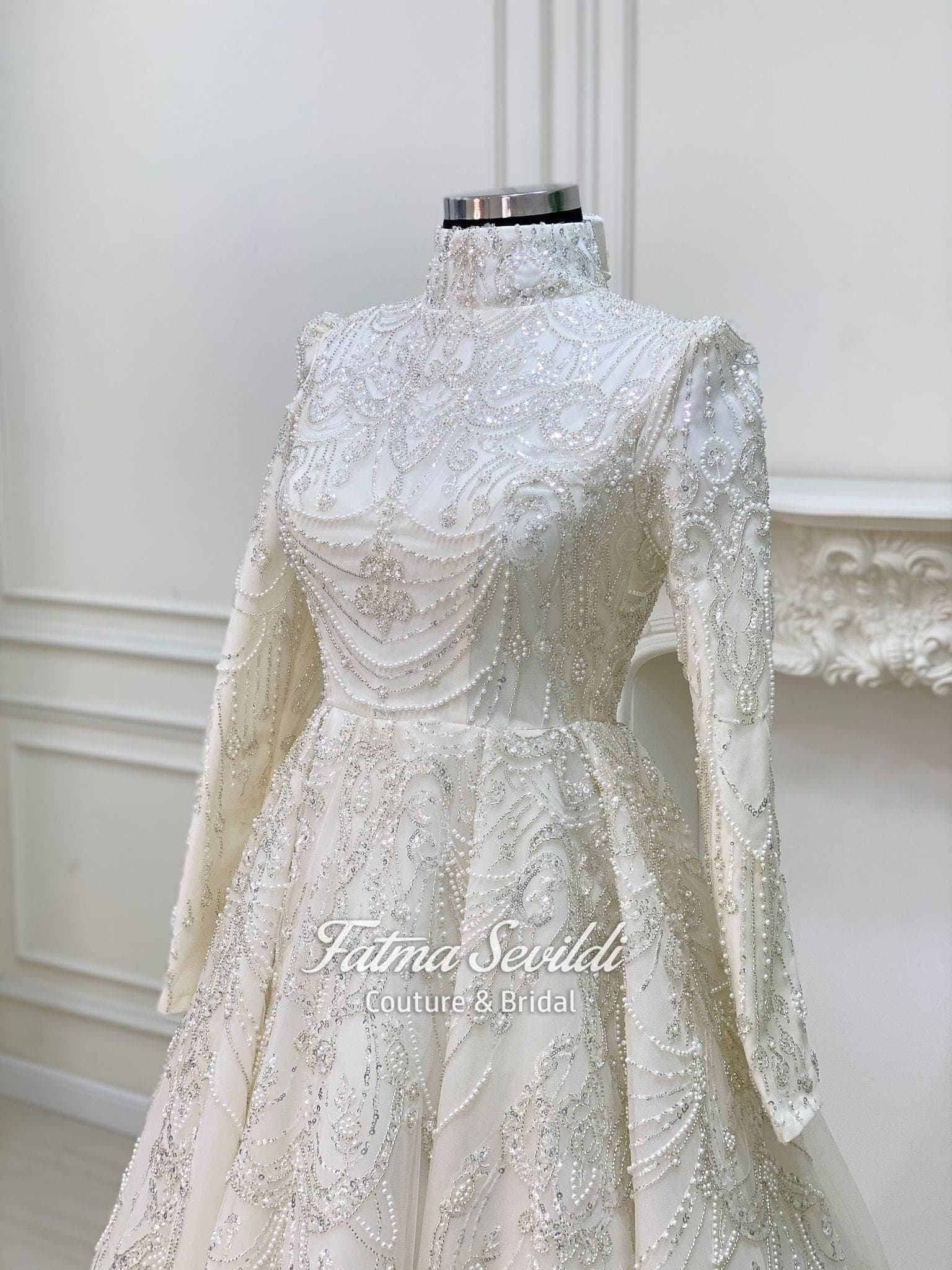 Luxury hijab wedding dress with high neck, long sleeves, and hand-beaded lace on an A-line modest bridal gown, custom made.